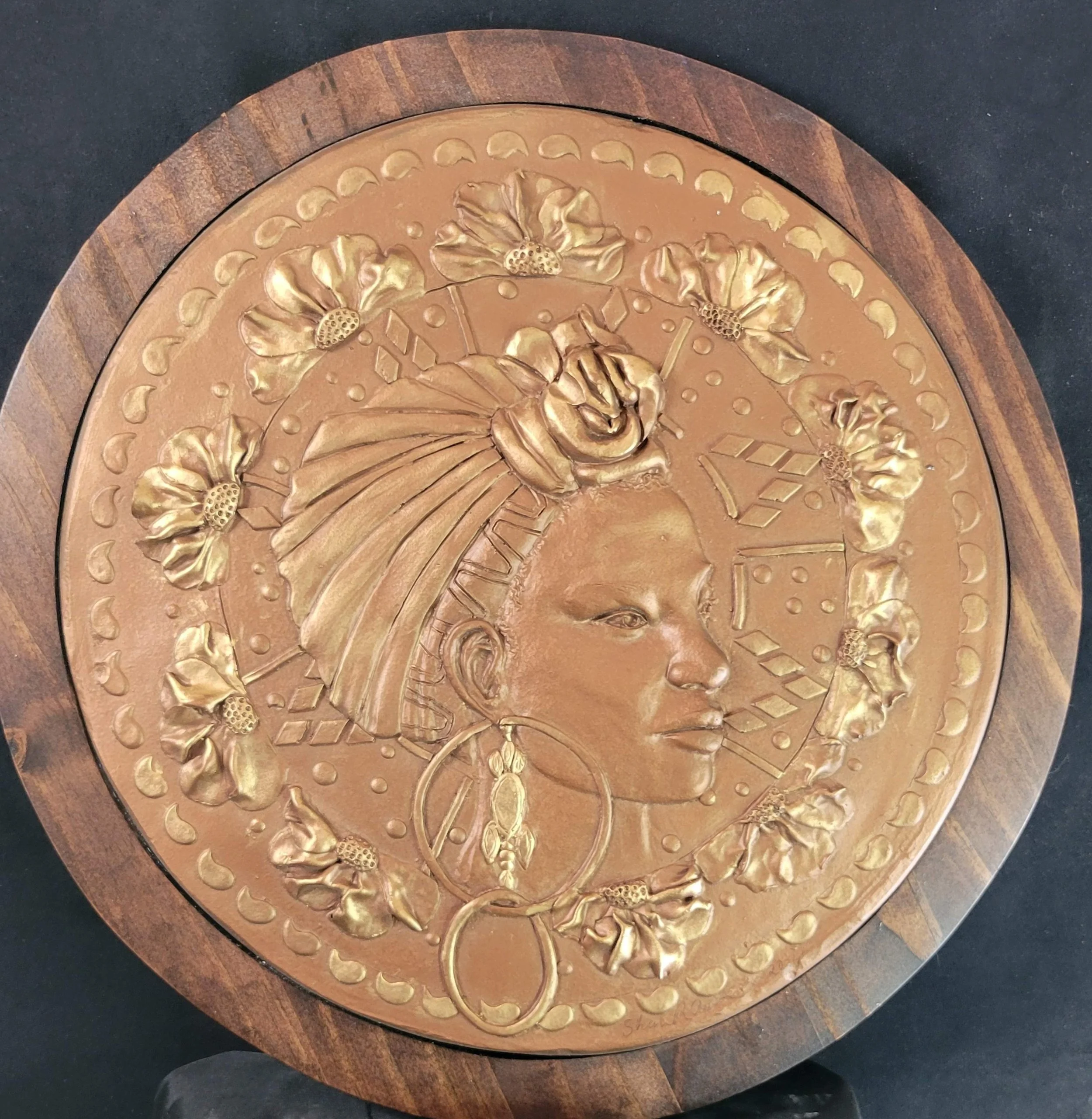 Grace in Heritage relief sculpture by Sharon Cruson, profile portrait with floral details and copper-infused finish