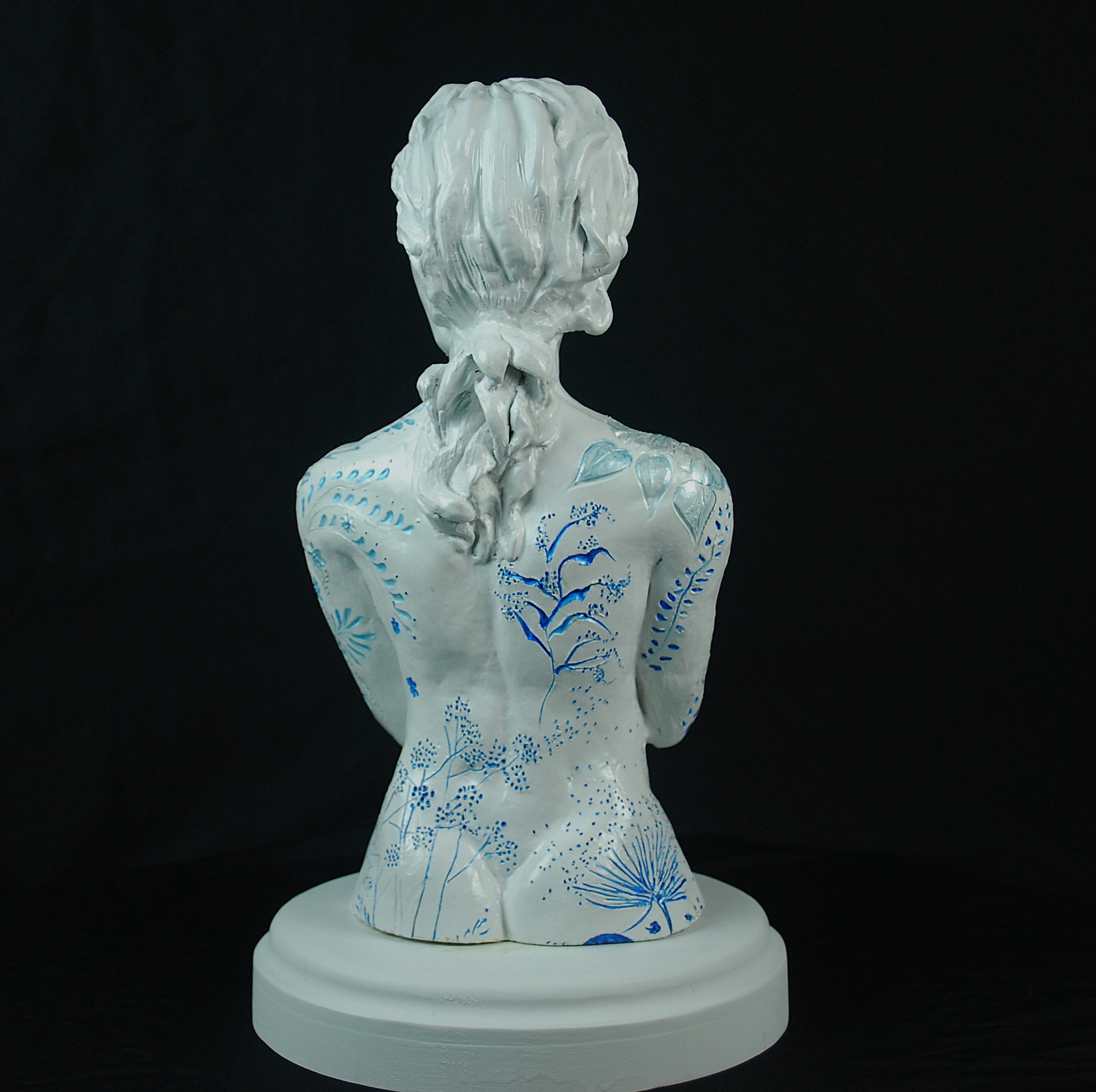 Cover Me in Springtime ceramic sculpture by Sharon Cruson, rear view highlighting braided hair and painted botanical accents