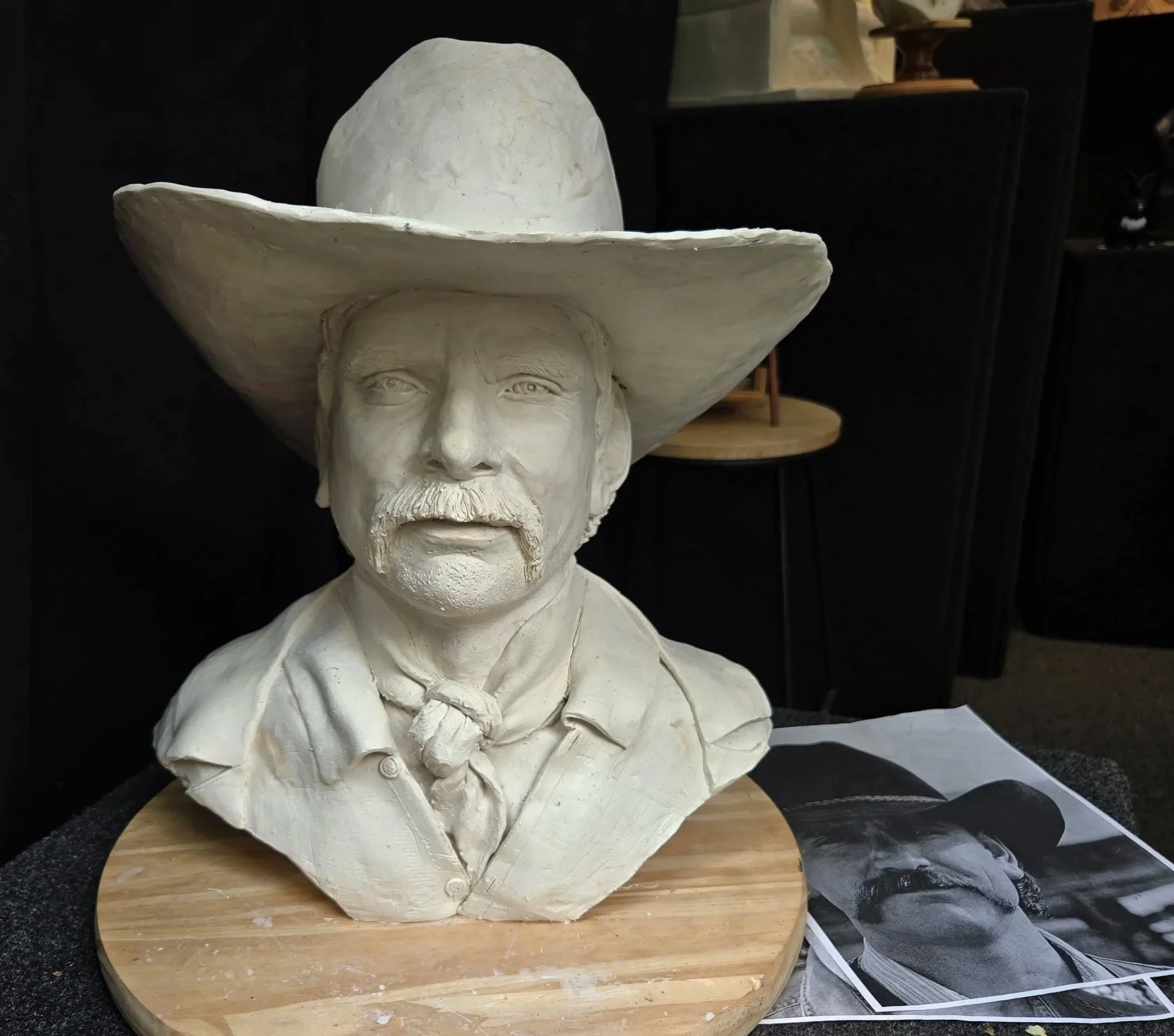 Portrait commission by Sharon Cruson, clay bust of a man wearing a wide-brimmed hat, shown in progress