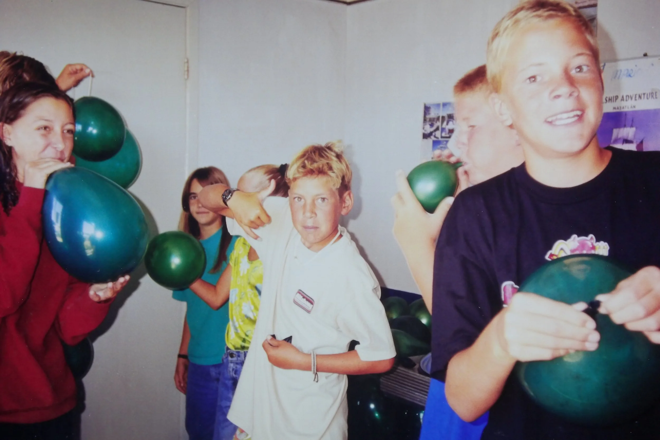 3.17.98 Kids blowing balloons for St Pattys Day.JPG
