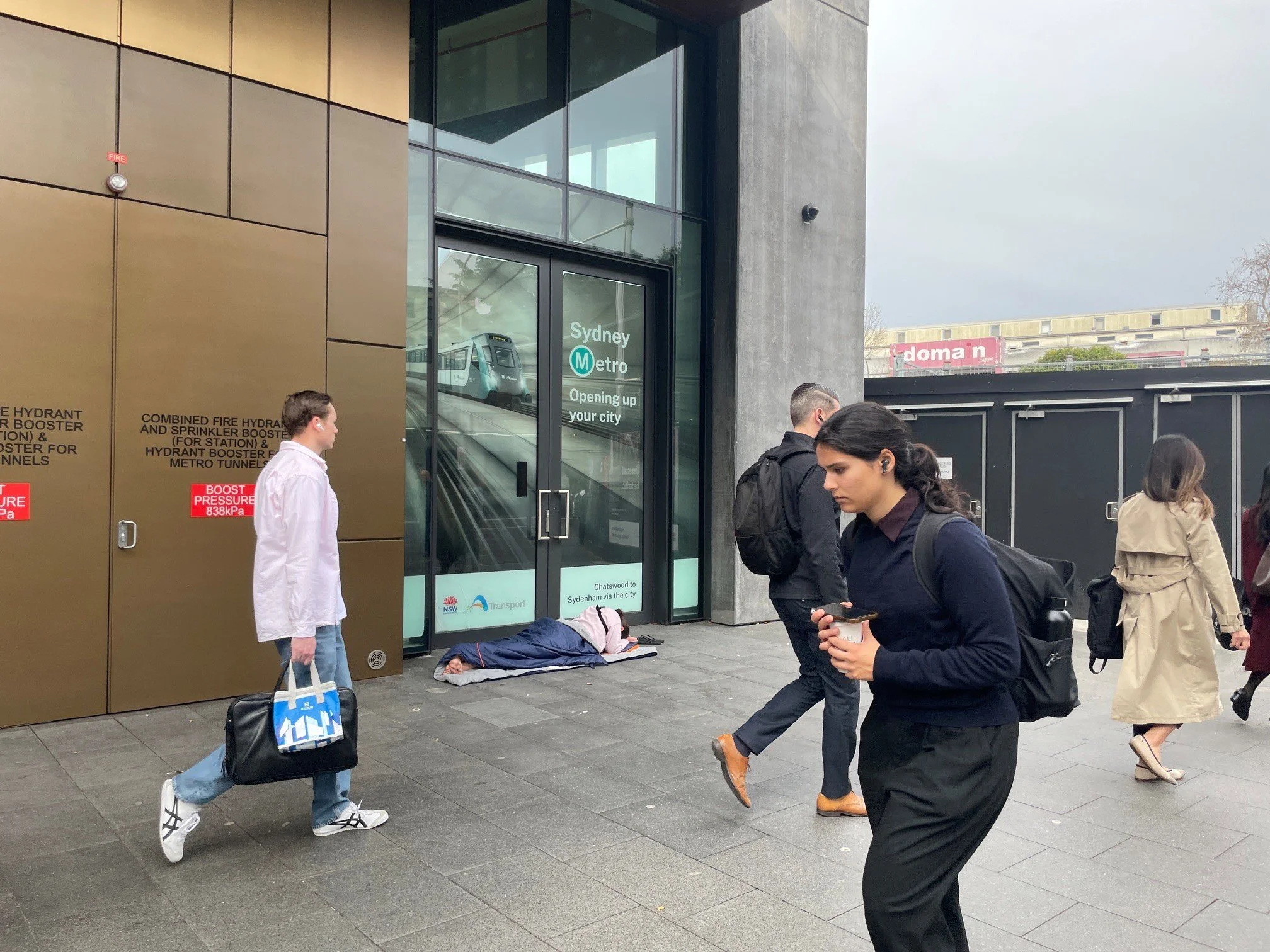 [Who gets to stay by Lin Yang] - While media coverage and political debate fixate on the housing crisis through the lens of first-home buyers, this image reminds us to look lower, to the ground level of this crisis. Here, City commuters stream past a