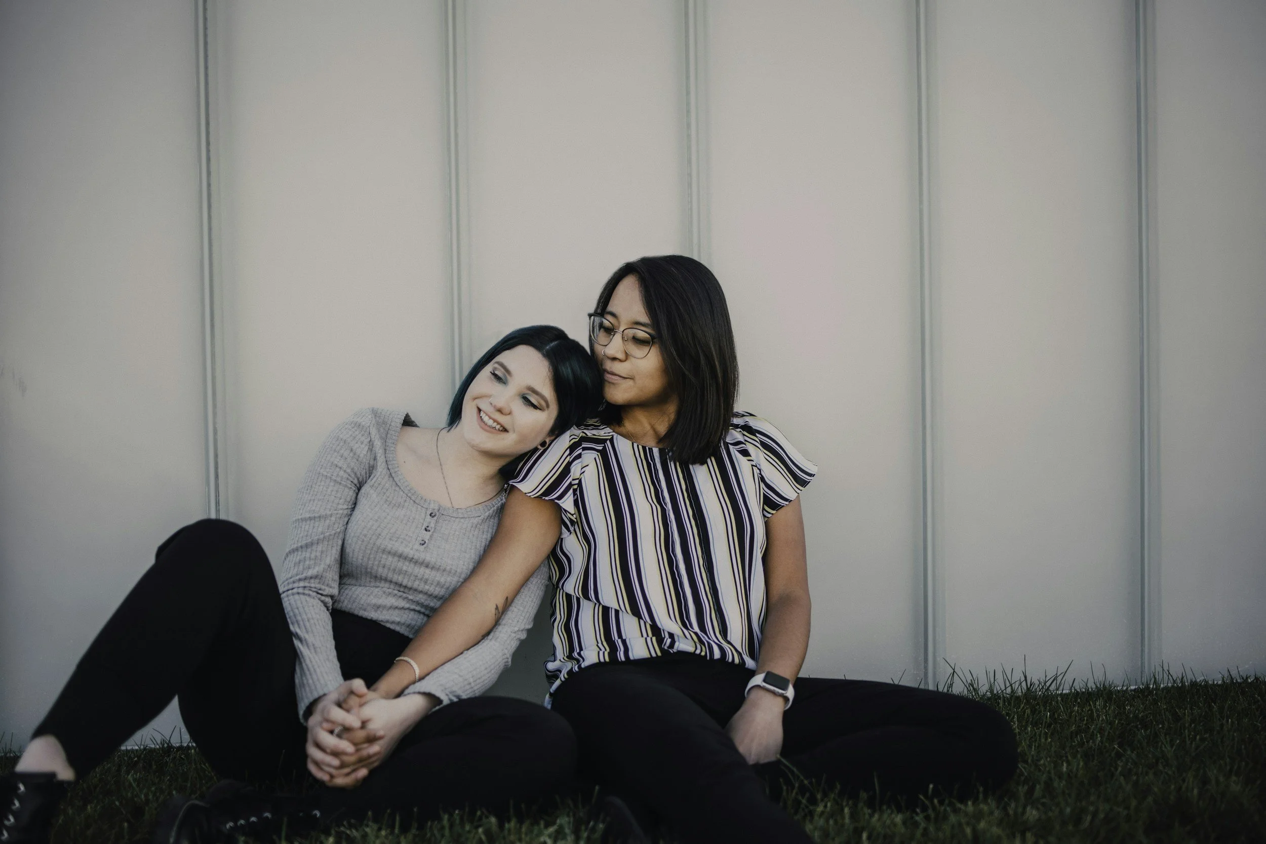 Mum and daughter leaning on each other.