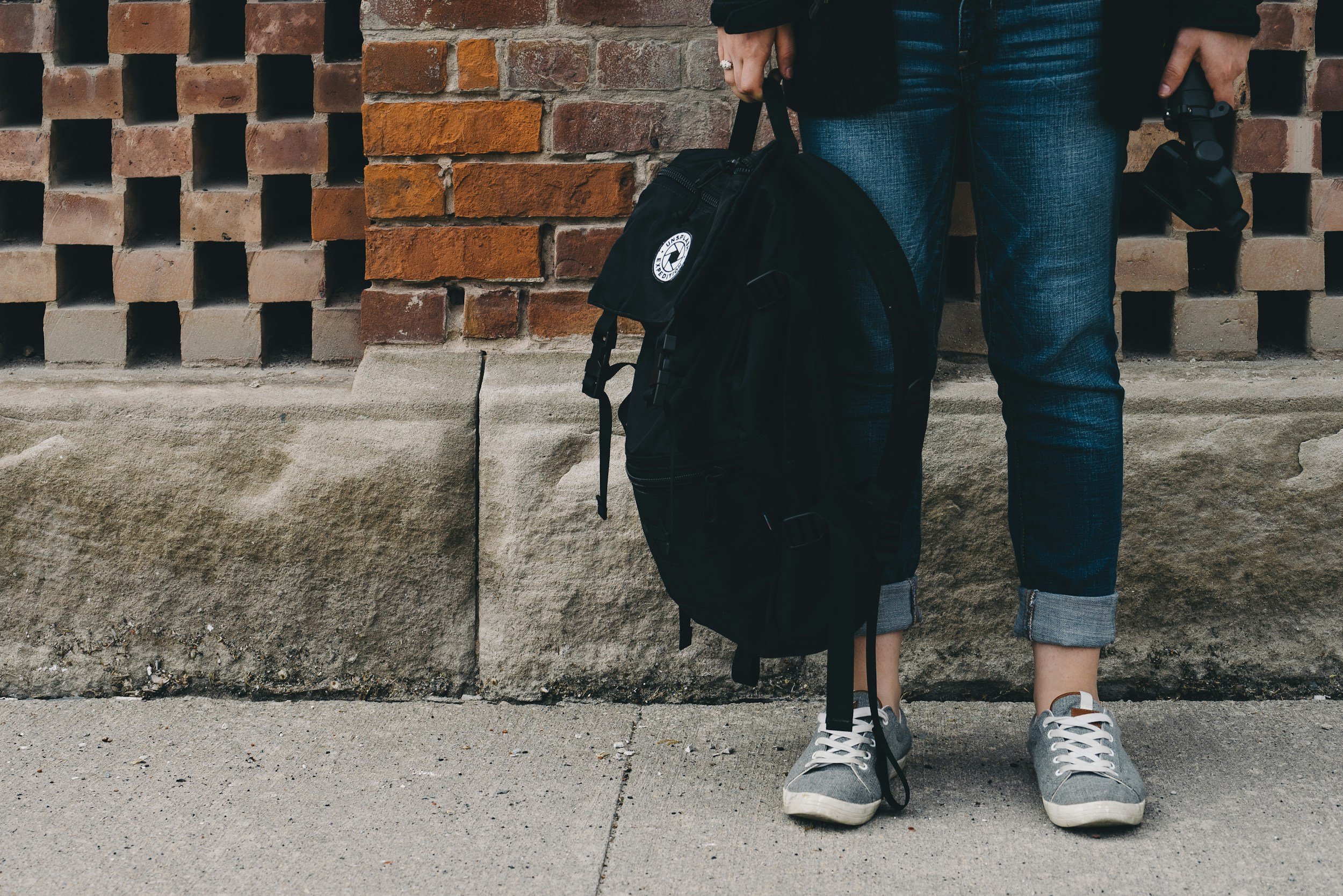 Teenager standing anxiously alone outside school