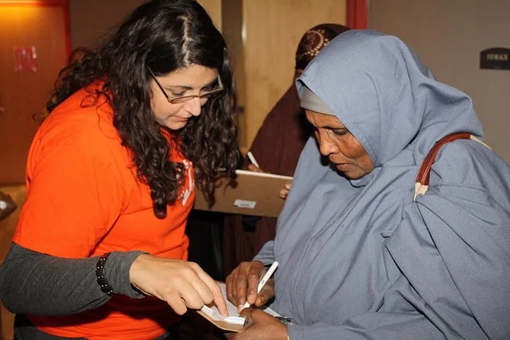 Leader from OneAmerica registering a new voter