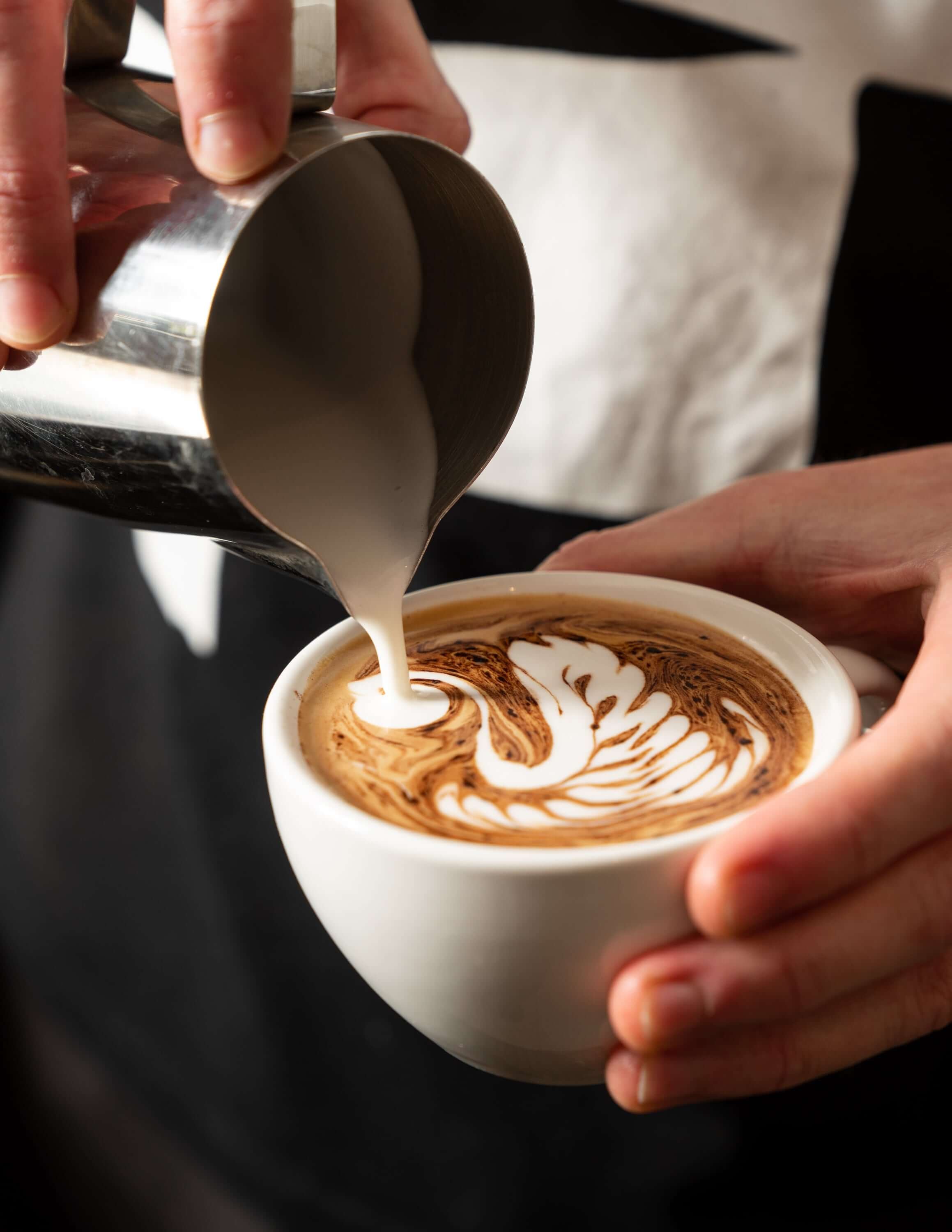  Pouring latte art barista making a cappuccino  