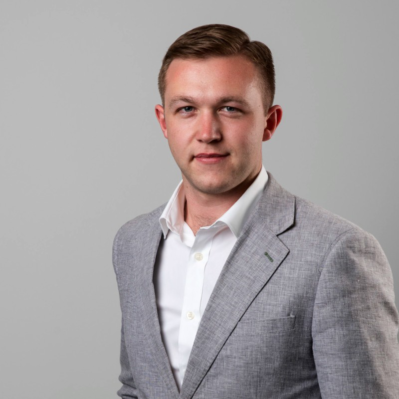 Levi Young from Contour Interiors posing in a gray suit