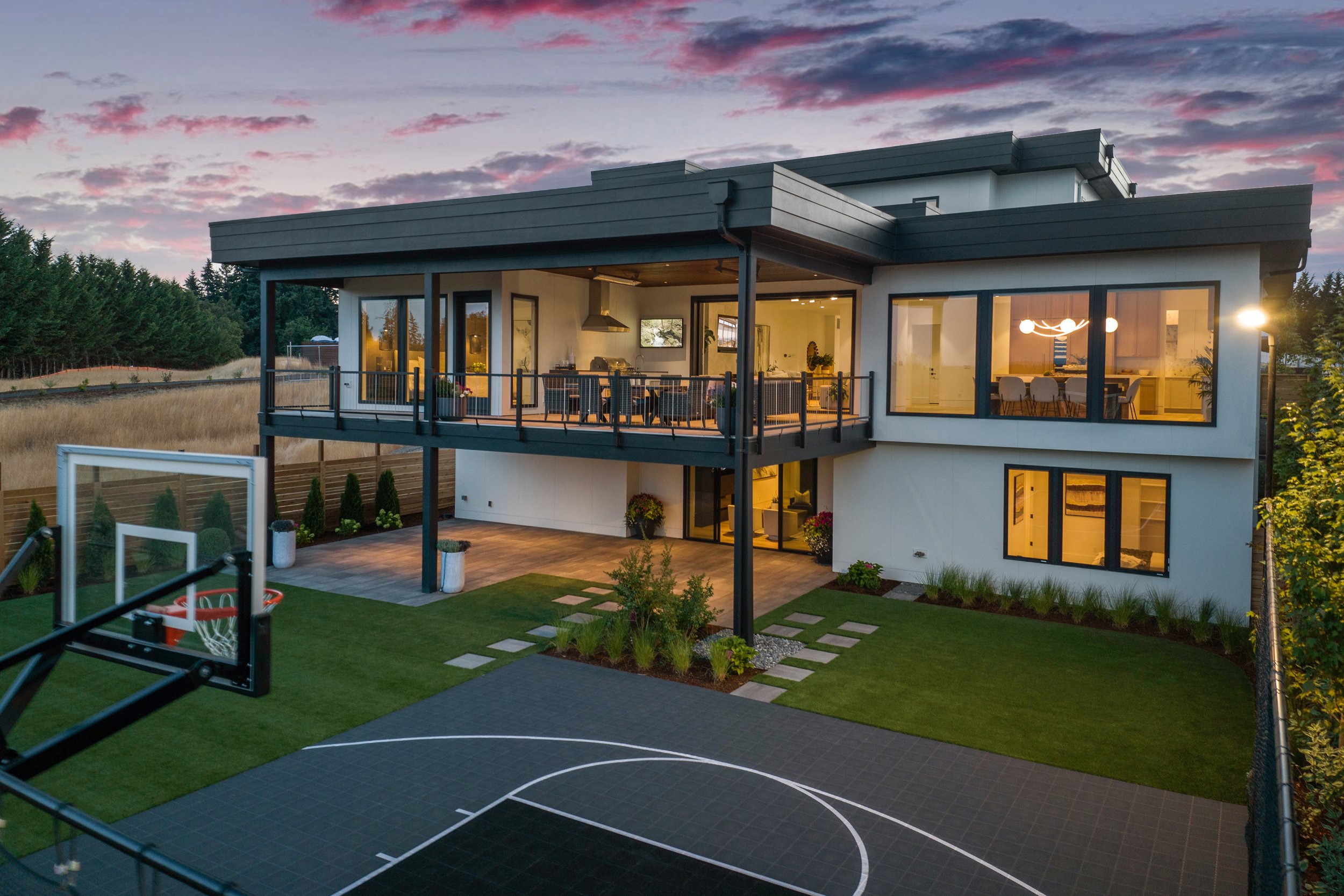 A stylish residence with a basketball court and a deck, offering both recreation and comfort.