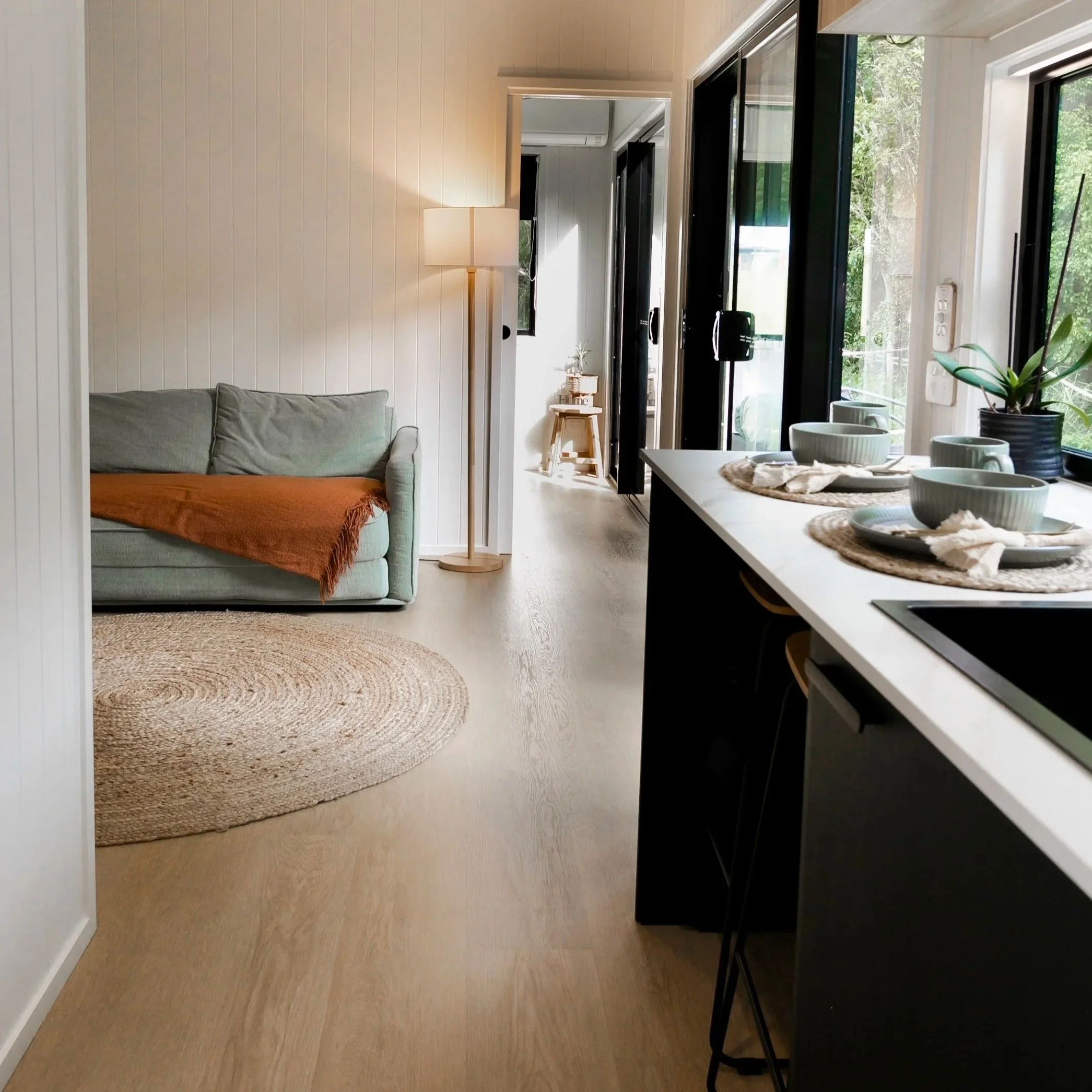 Studio Series 1-bedroom tiny home on wheels with breakfast bar and large bathroom