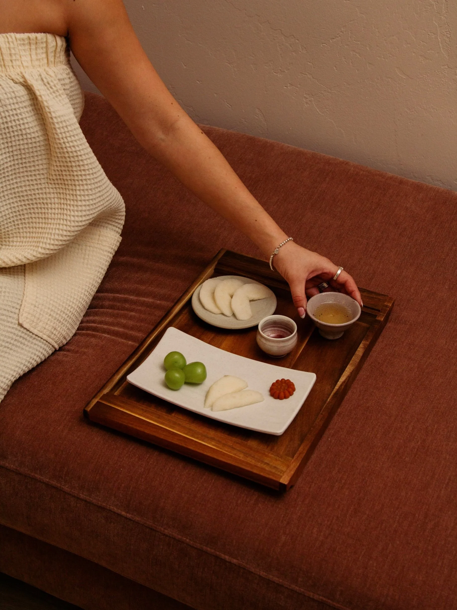 The moment after treatment always feels like a return.

Warm tea. Something sweet. Skin still breathing from the work that was done. This is part of the ritual too.