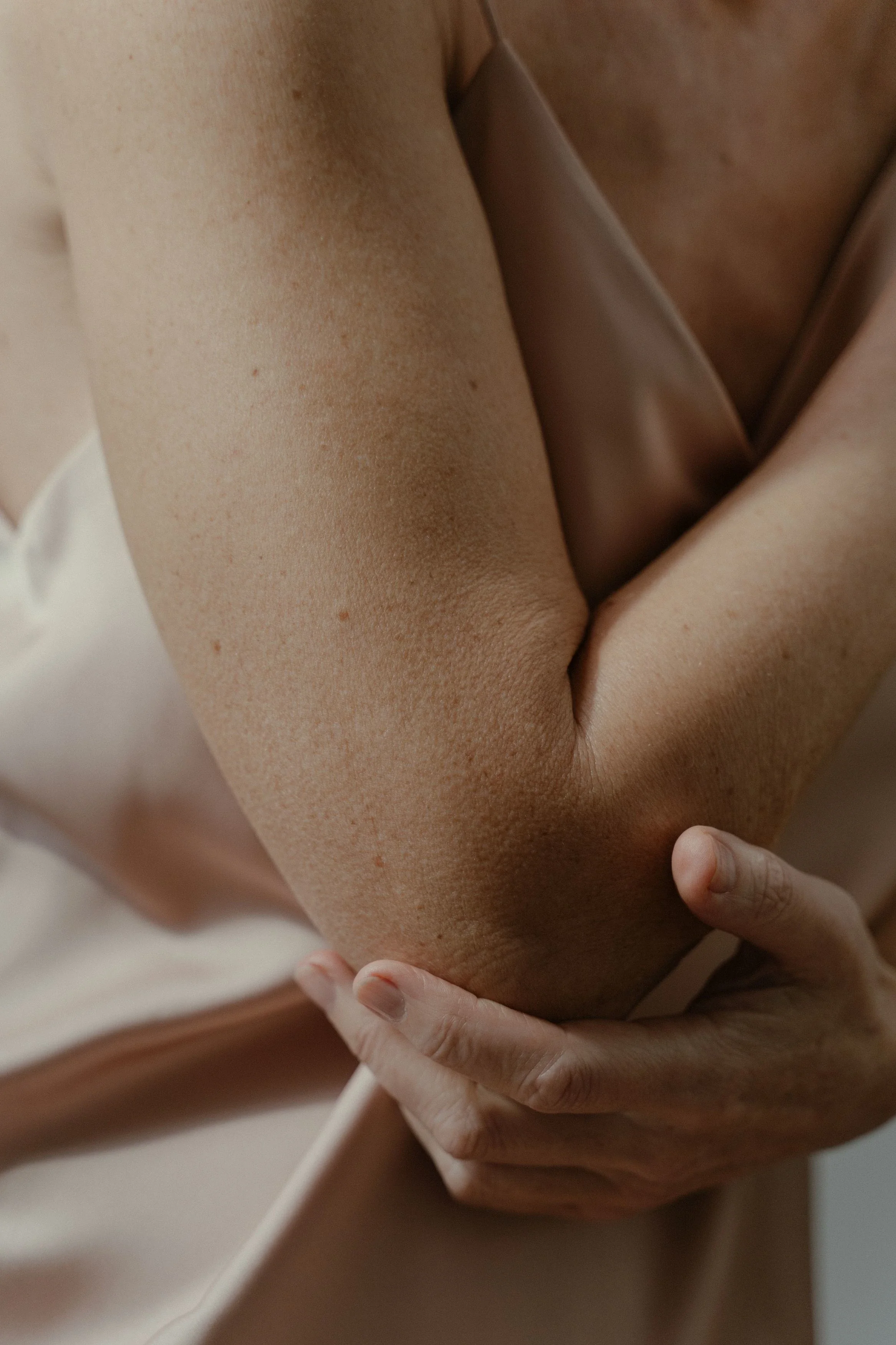 Person holding their elbow due to elbow pain