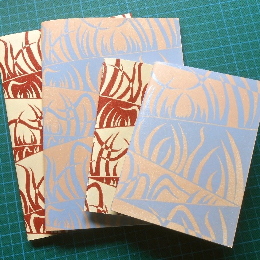 Some of you may not know that in addition to making one or two bits of artwork, I also hand print covers for a range of hand made notebooks. 
These are available exclusively from my other Etsy shop 'Three Cats in A Tree' (copy and paste the link belo