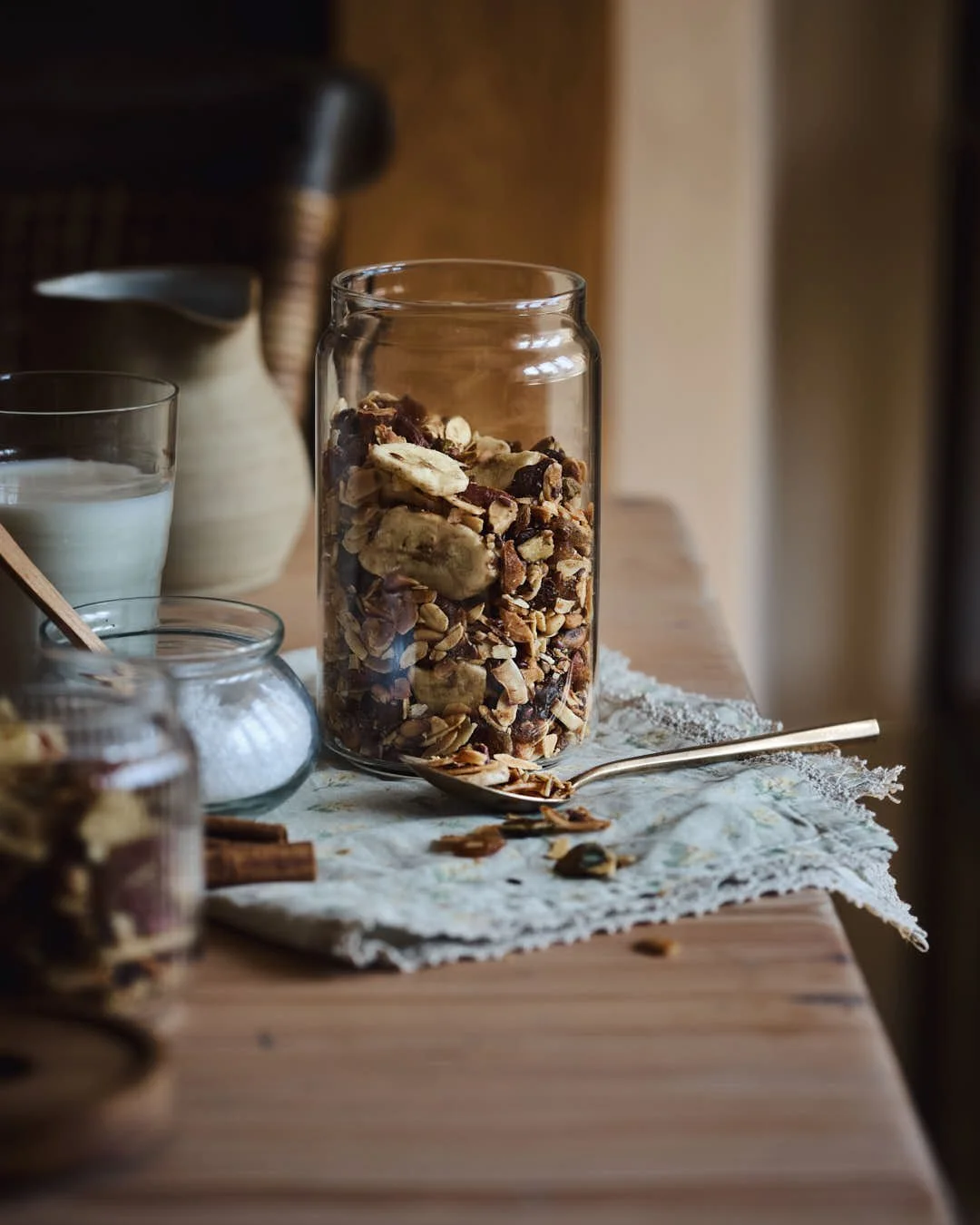 straight on image of jar of granola in rustic farmhouse table setting