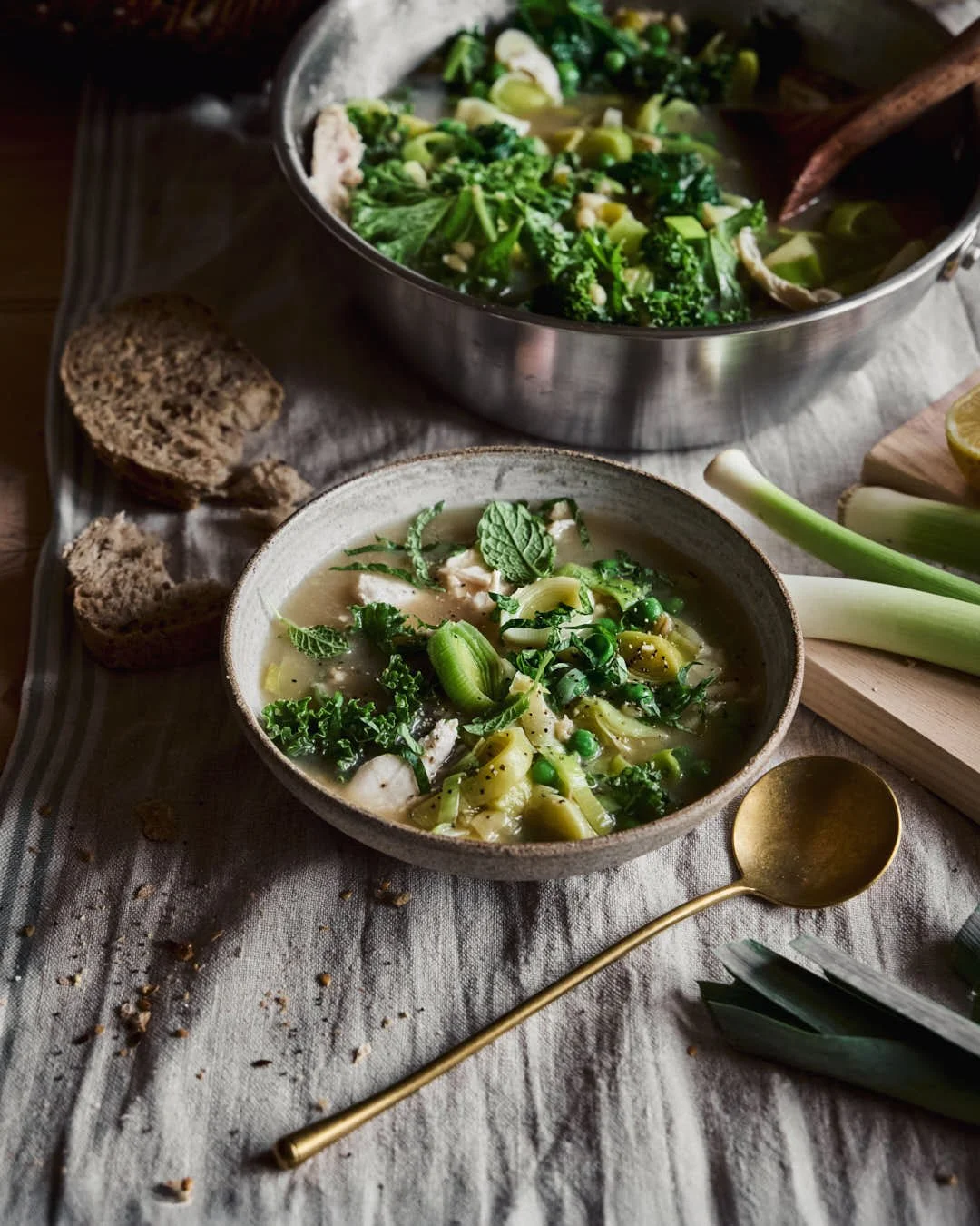 angled image of cock a leekie soup on cool toned linen table