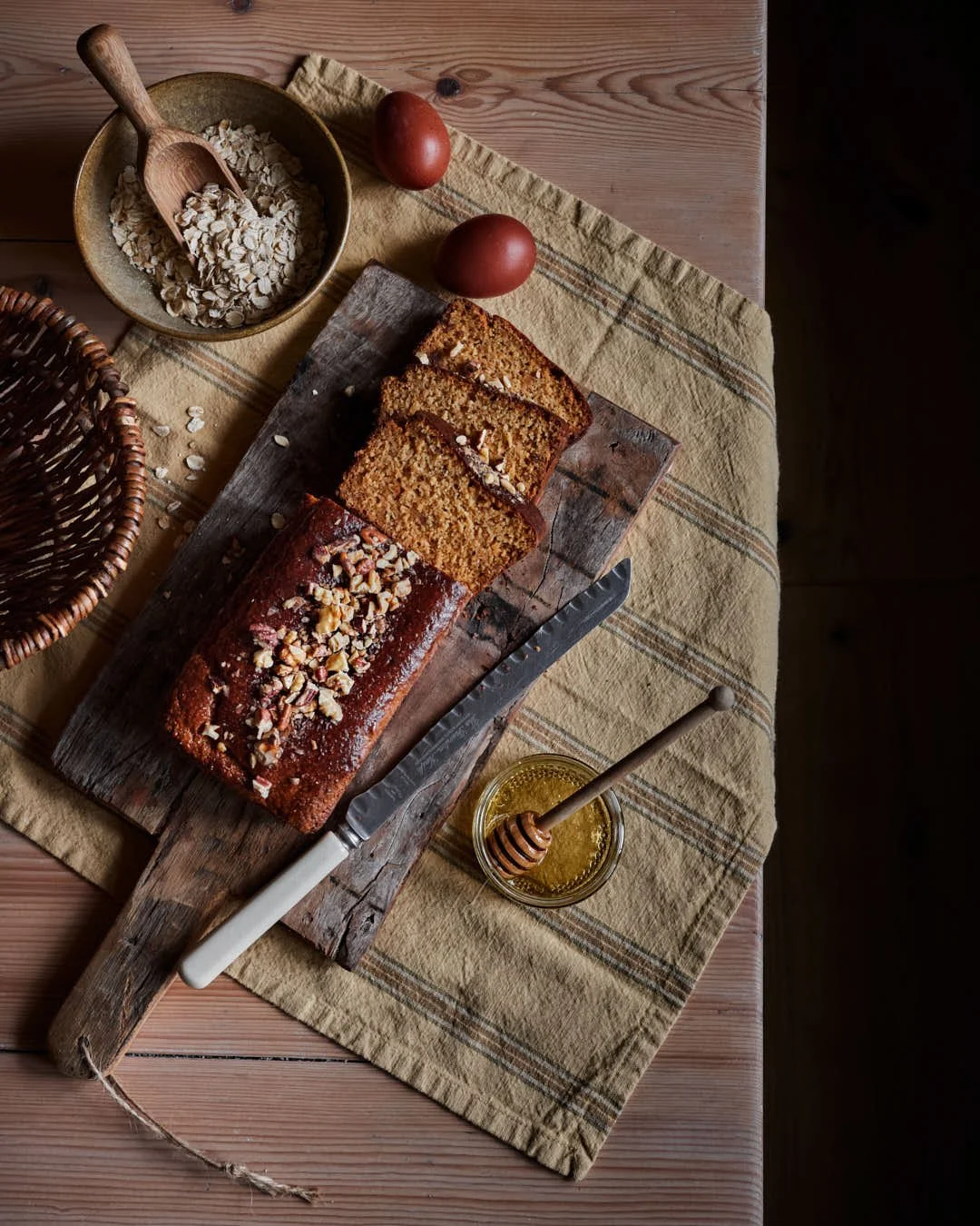 flatlay image of peanut, honey & oat cake on rustic table with vintage vibes