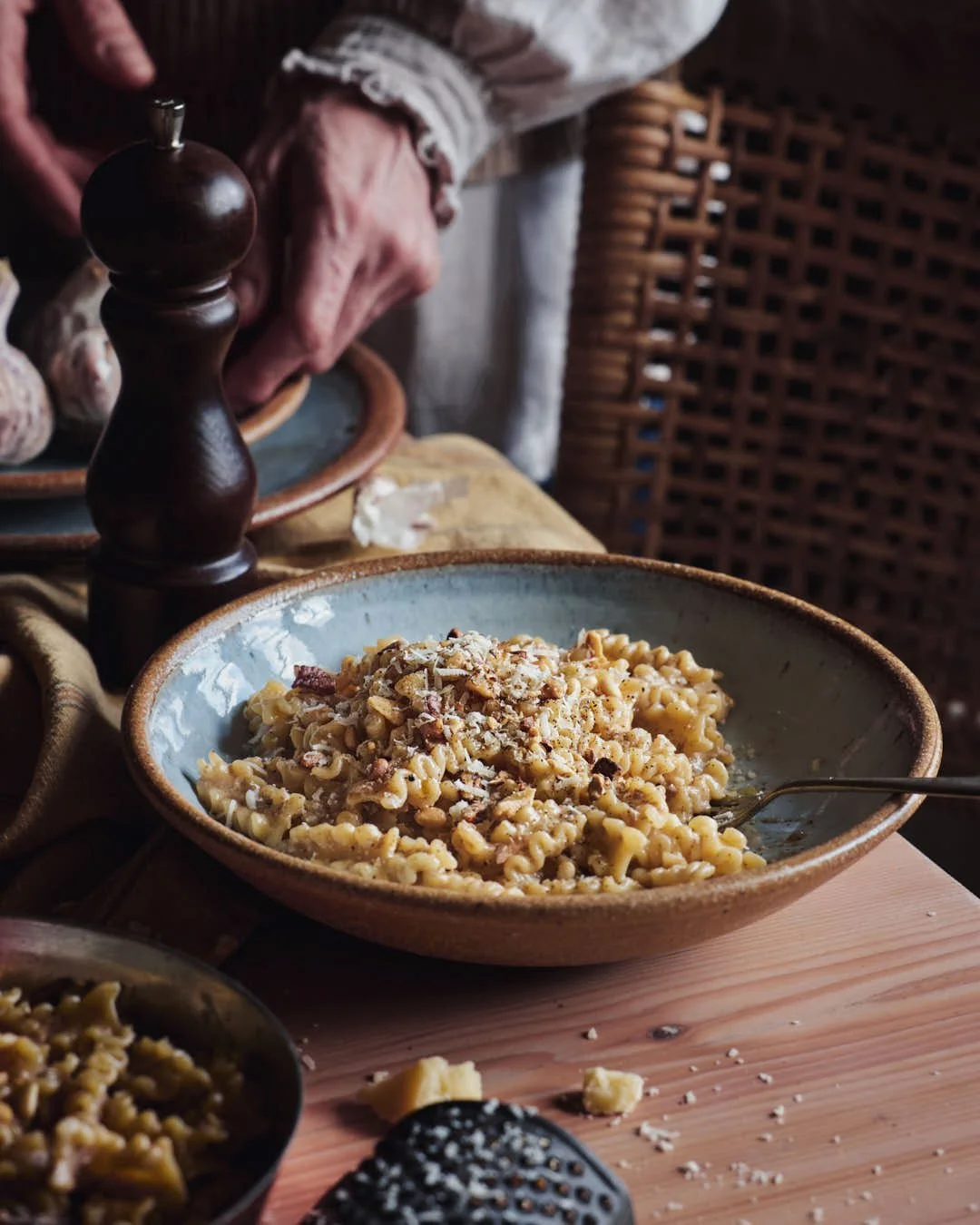 angled image of pasta in bowl on farmhouse table