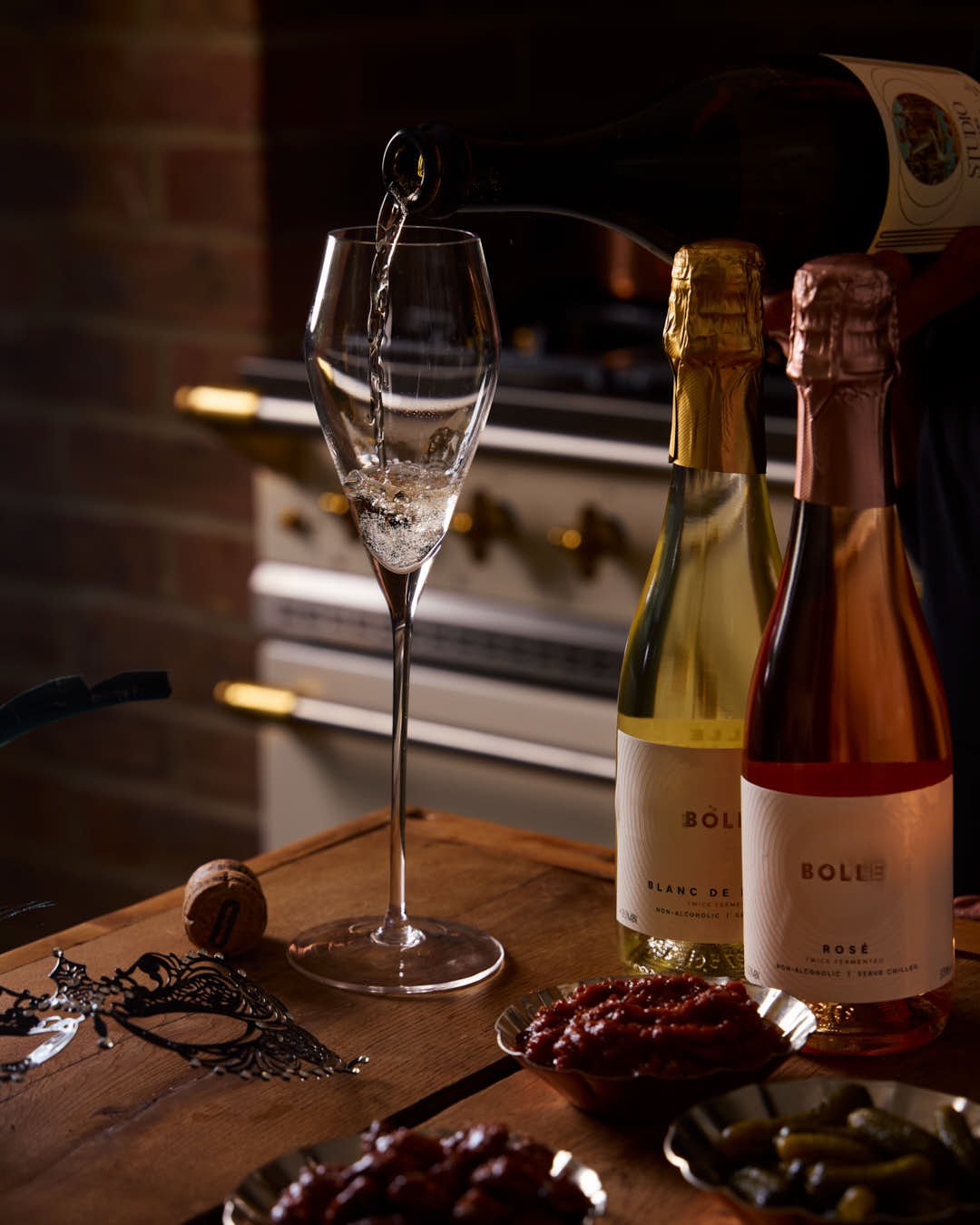 champagne being poured into glass in kitchen winter scene