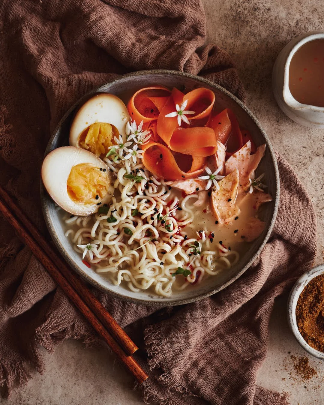 flatlay image of ramen noodles with eggs in rustic scene