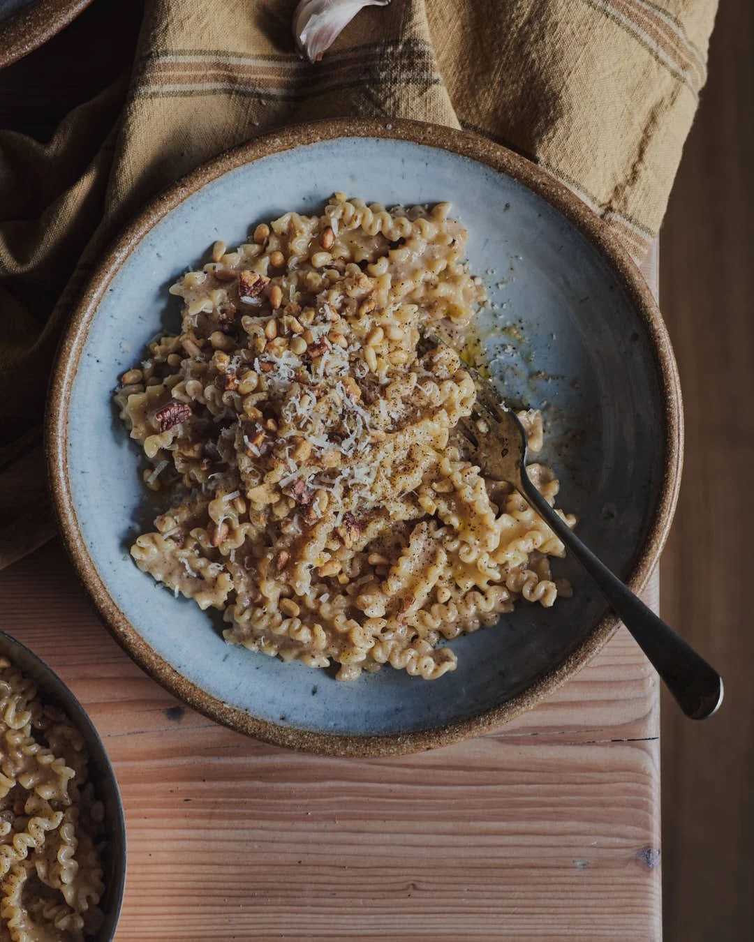 flatlay image of pasta in bowl with farmhouse table