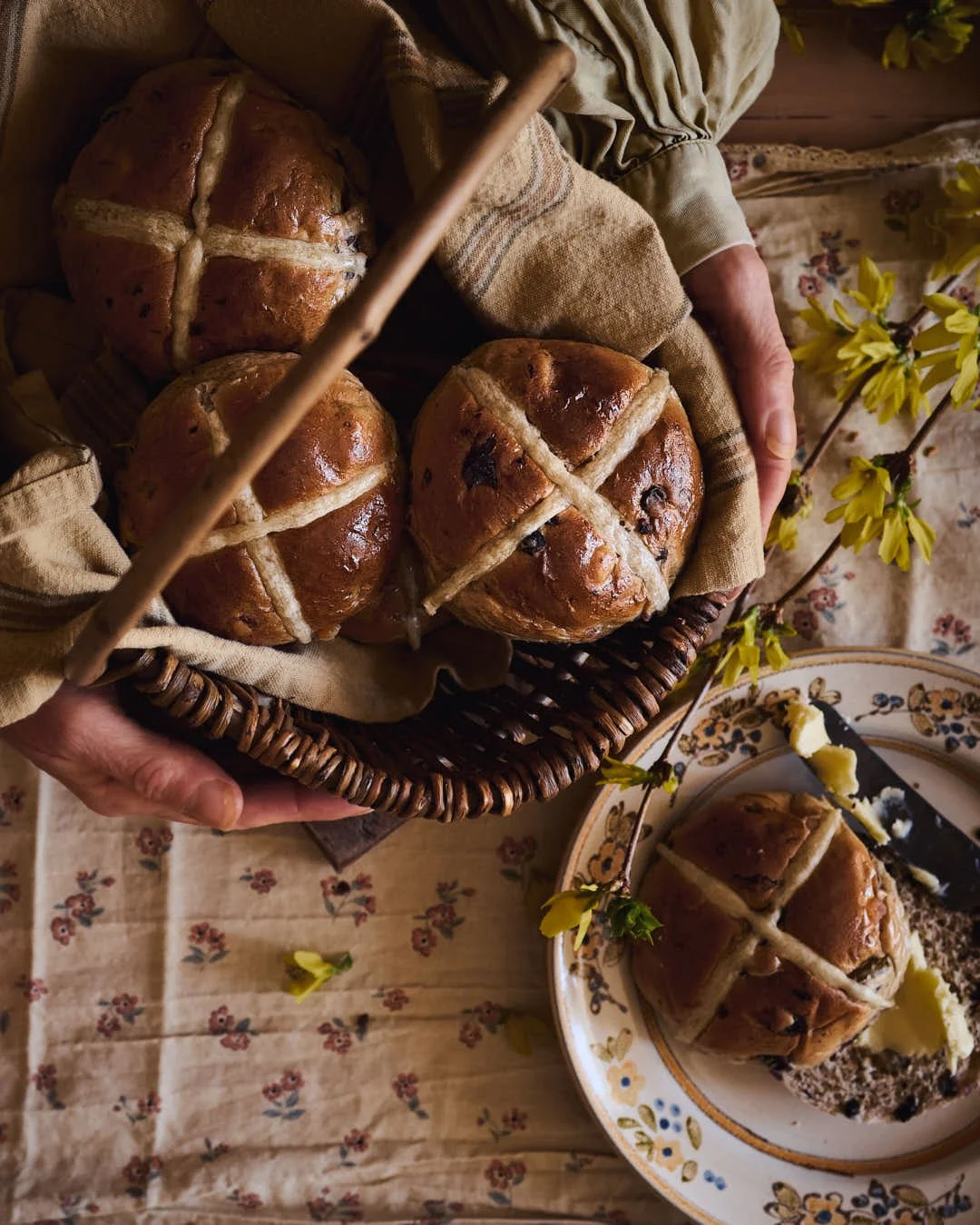 overhead image of girl holding hot cross buns in basket