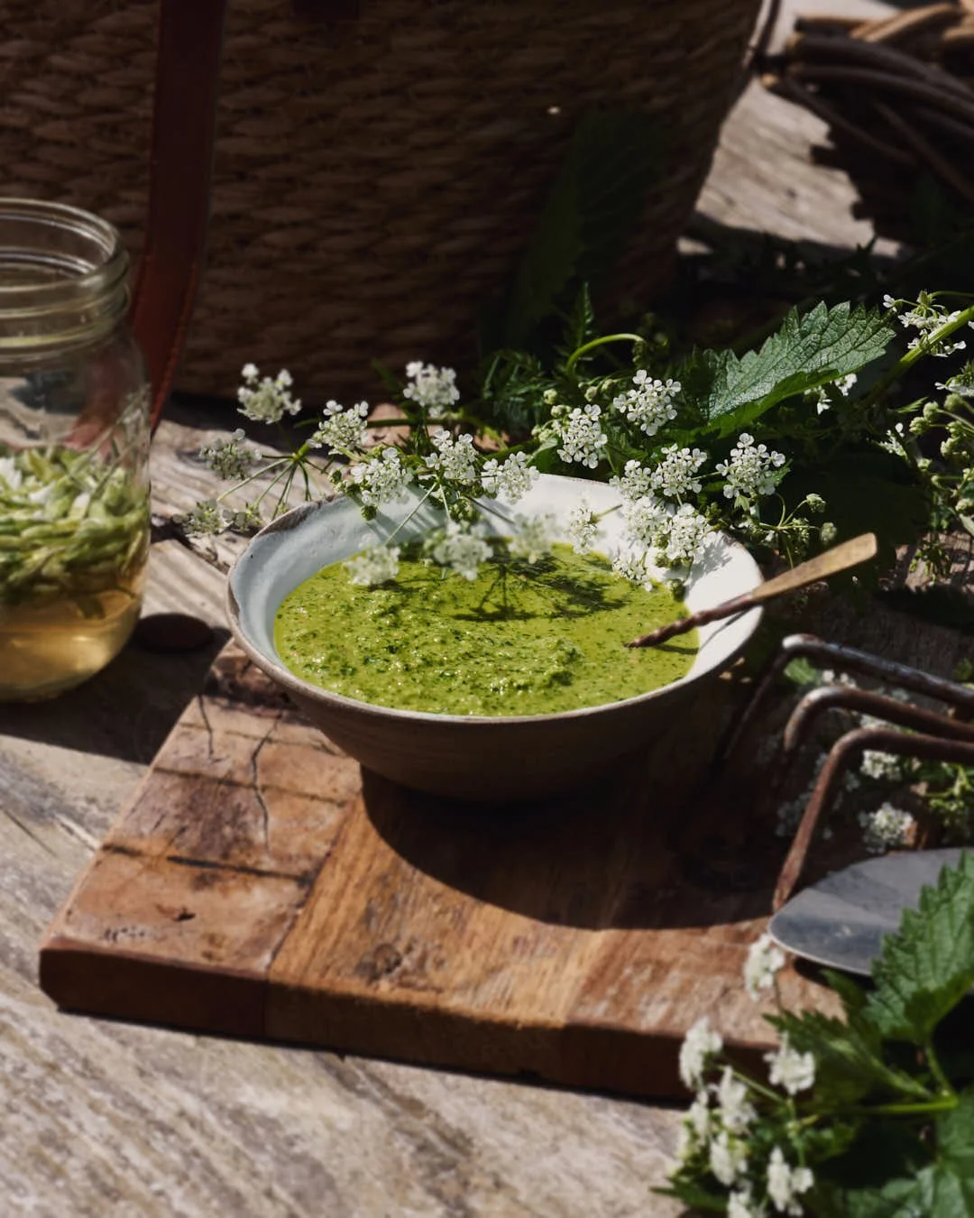 macro image of nettle sauce with cows parsley flowers