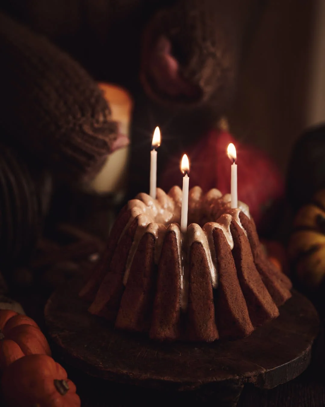 angled moody image of candles in fluted bundt cake
