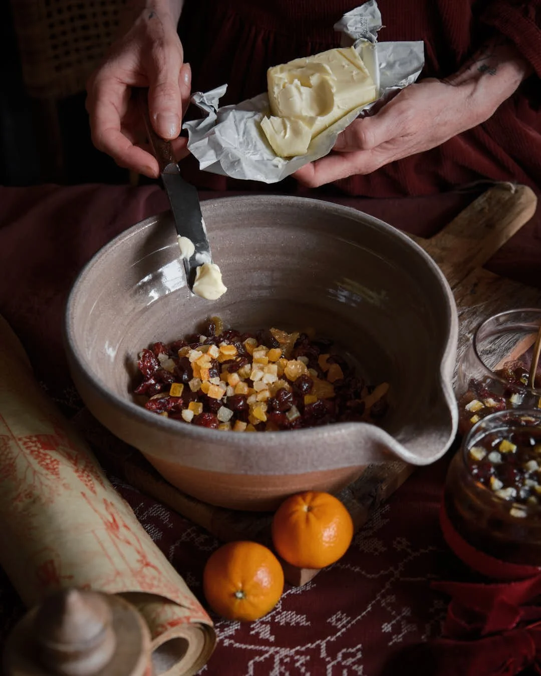 macro image of girl spooning butter into bowl of dried fruits