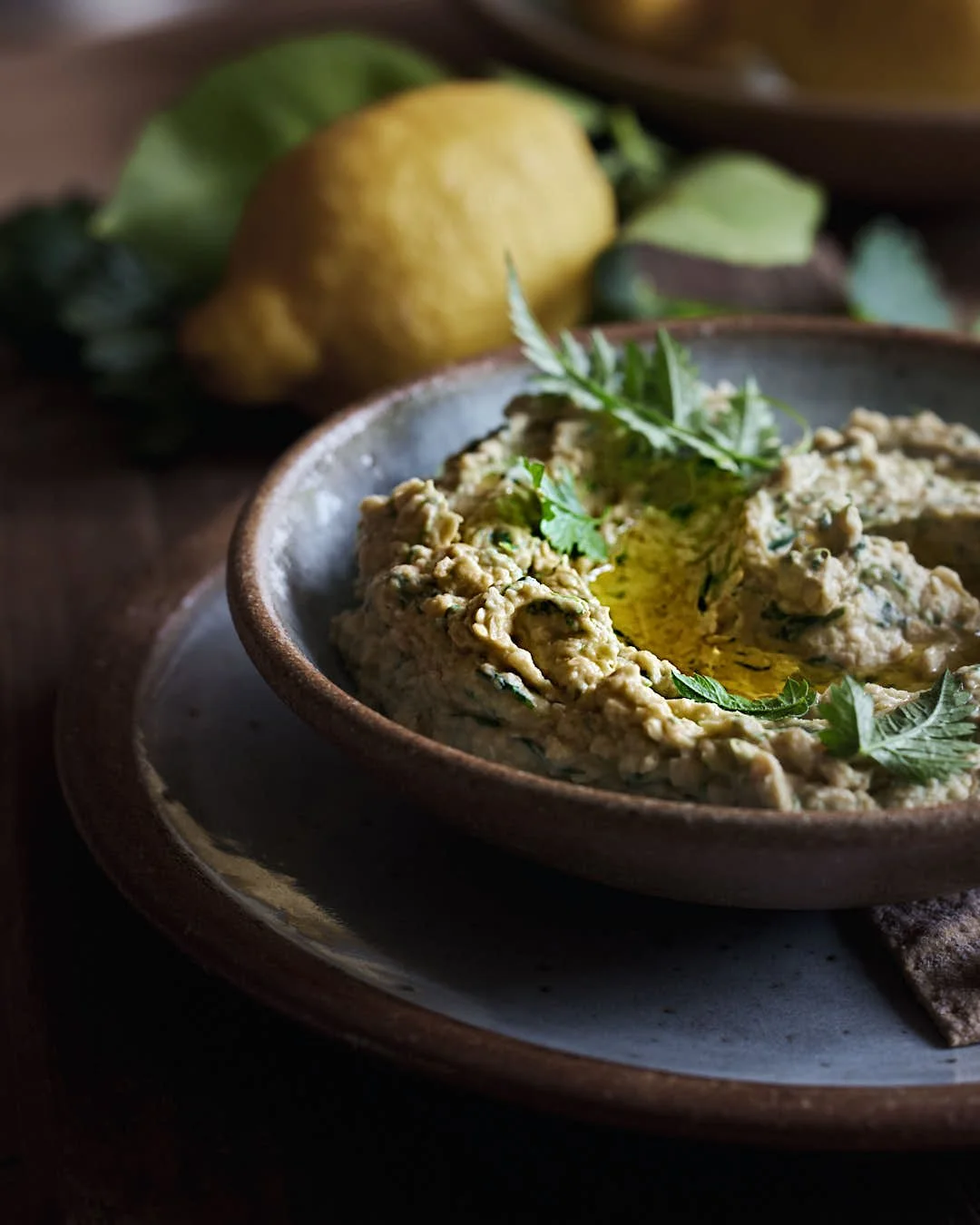 straight on macro image of hummus in bowl to show texture and glossy olive oil drizzle