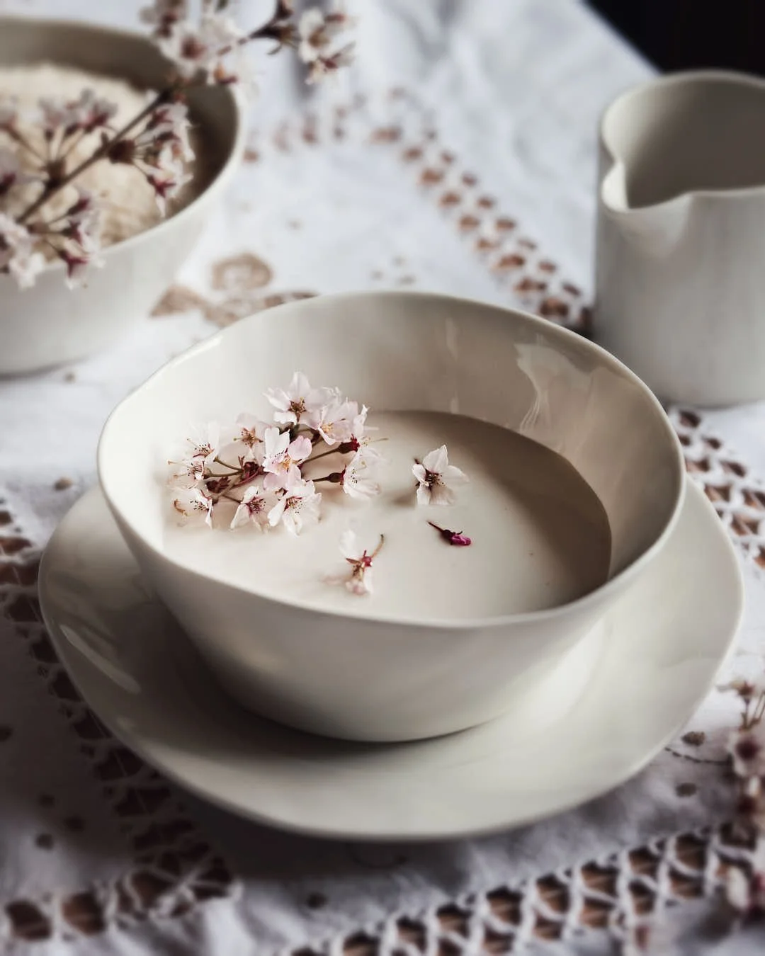 amazake in bowl with cherry blossom garnish