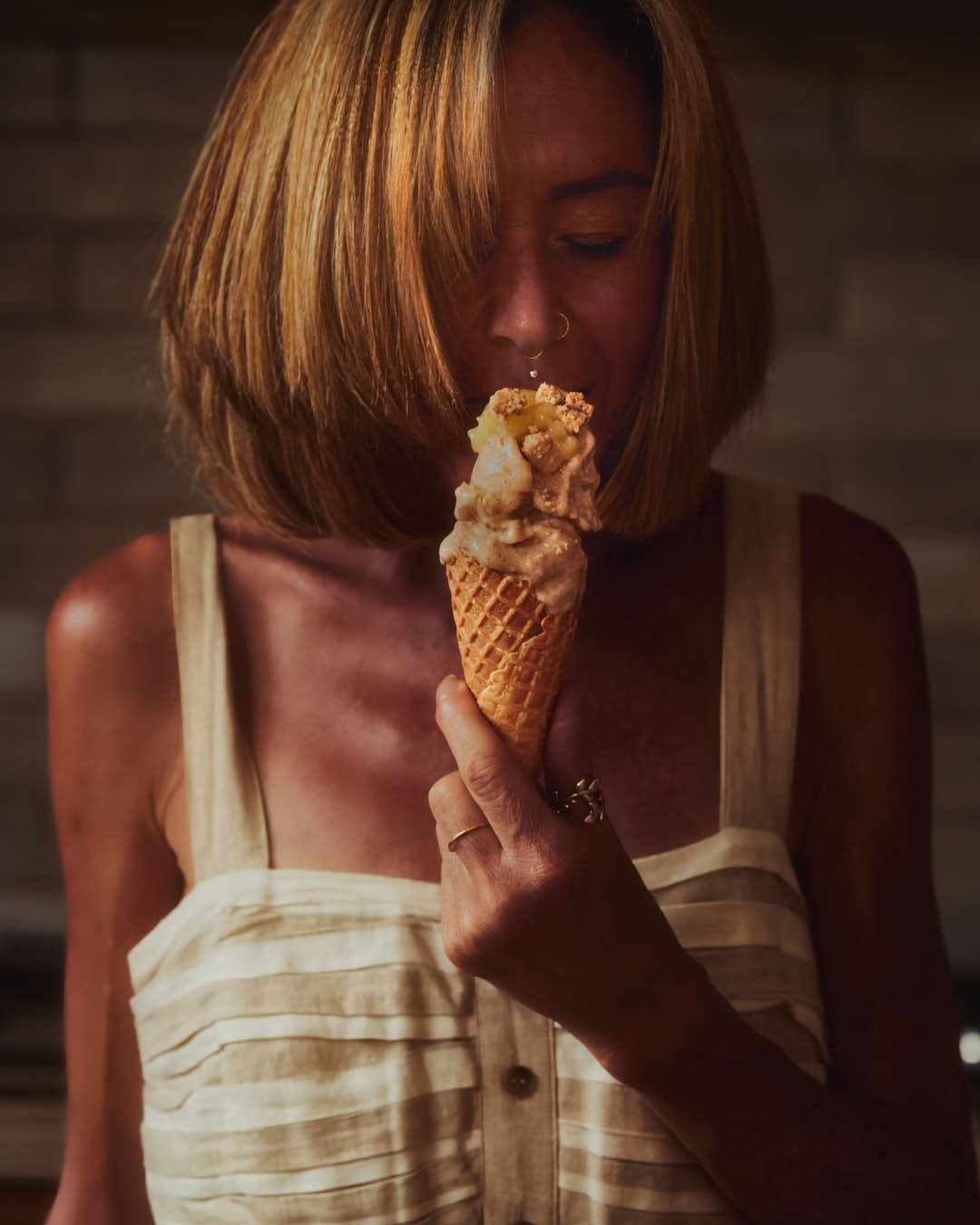 macro image of girl eating ice cream in soft summer light in kitchen