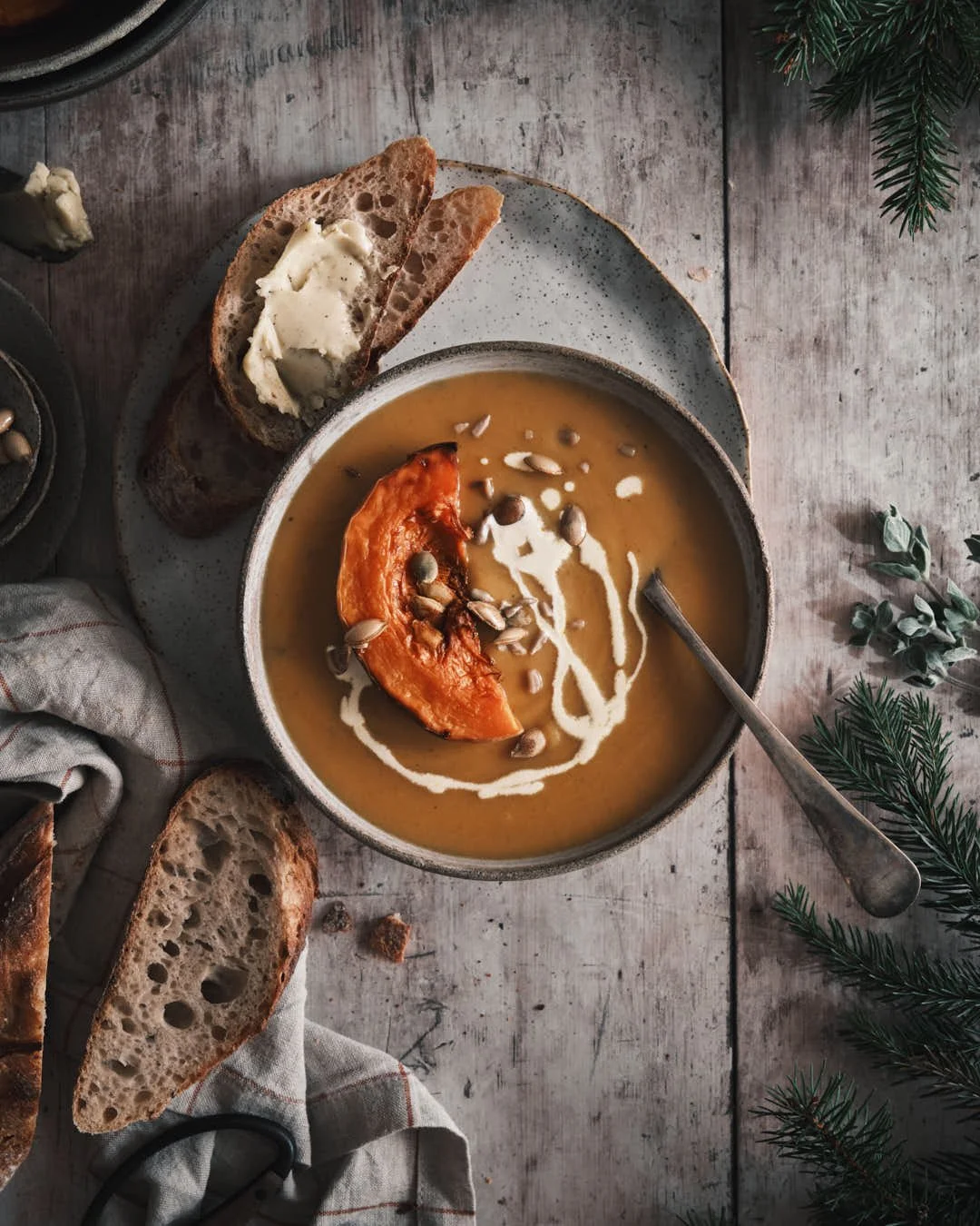 flatlay image of butternut squash soup on grey wood background