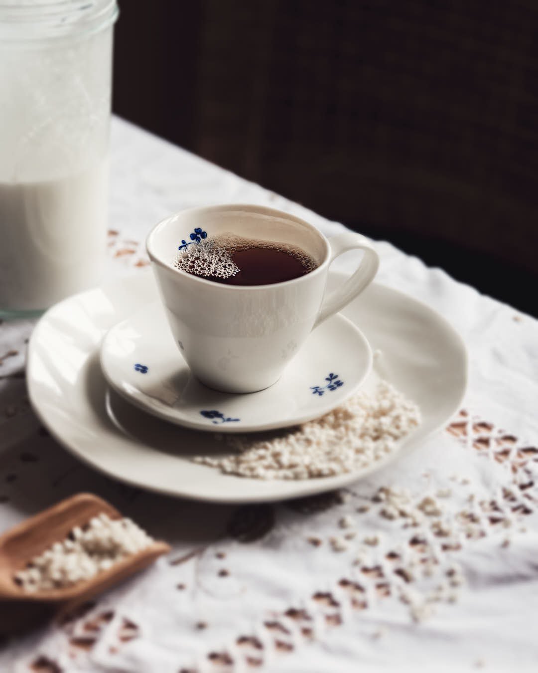 image of tea in cup with rice grains in bright yet moody image