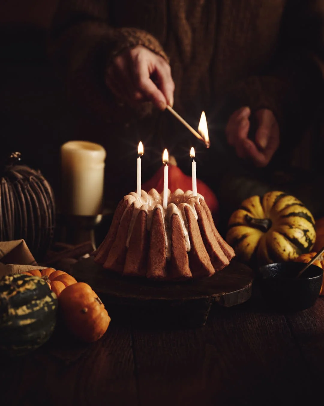straight on image of girl lighting bundt cake