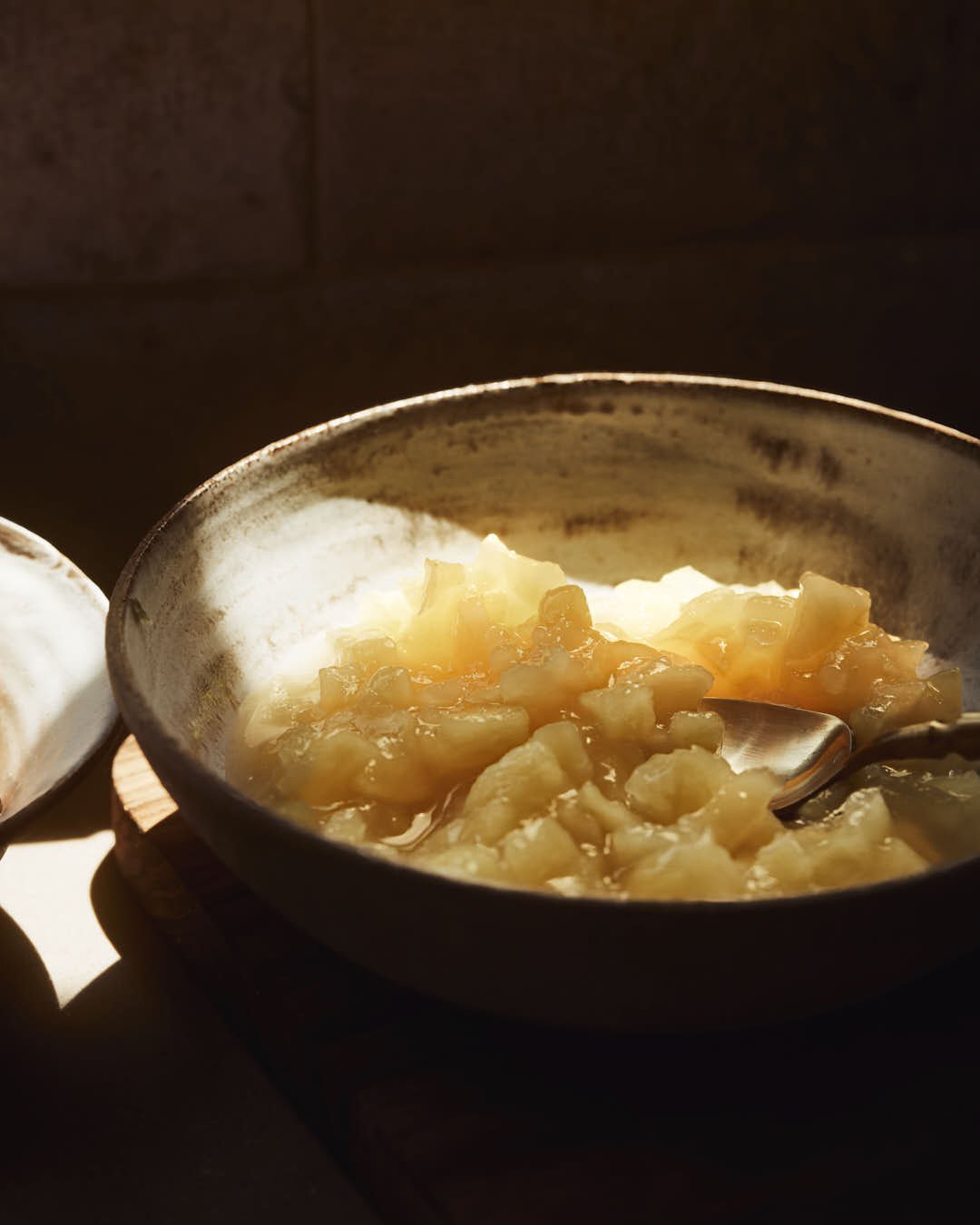 macro image of apples in a bowl in chiaroscuro
