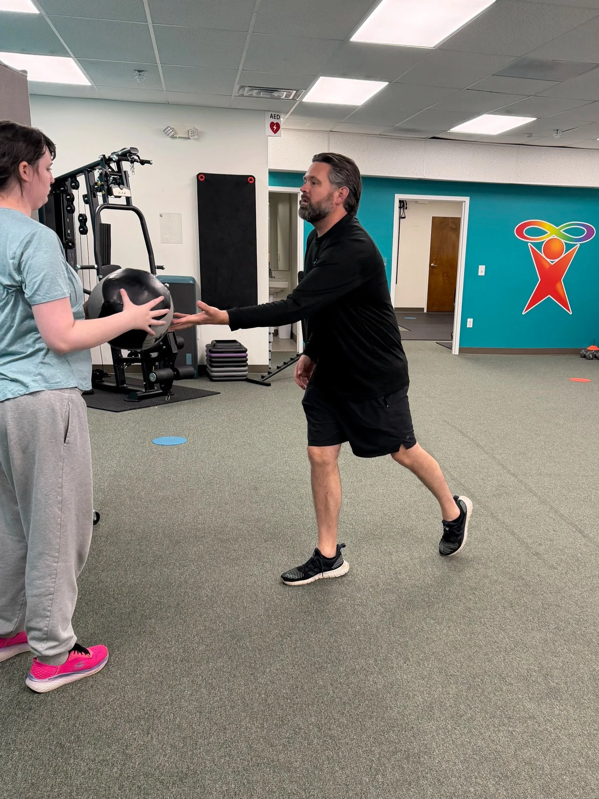 Support-first fitness trainer during exercise session at Full Spectrum Fitness