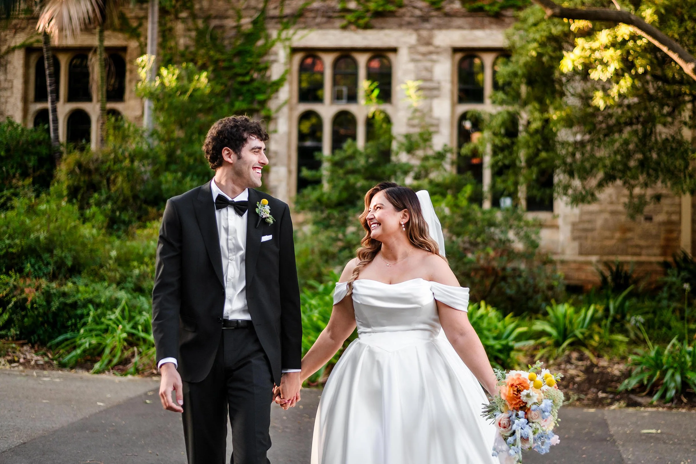 Wedding couple at UWA with lush greenery and architecture as a backdrop