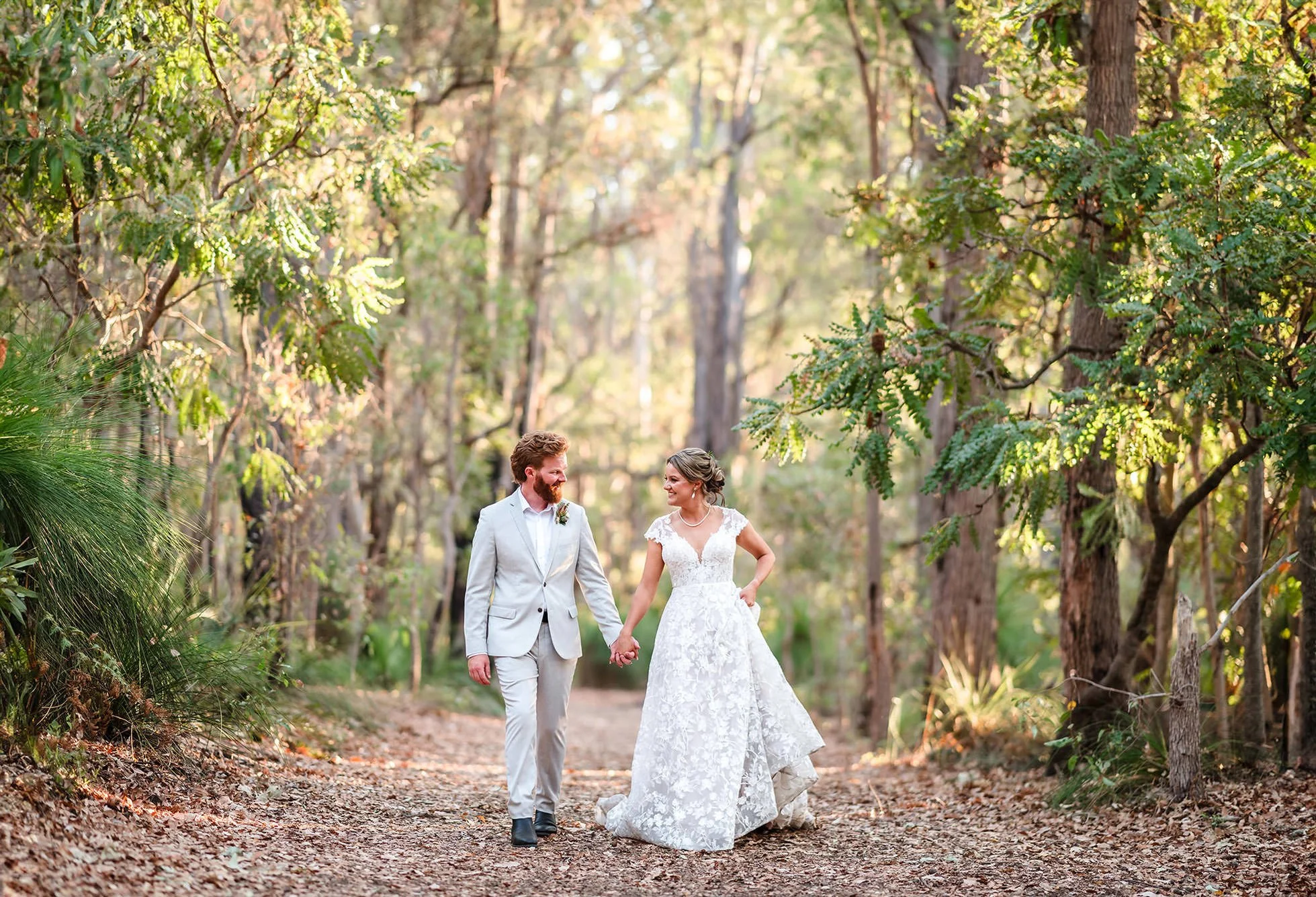 Couple strolling through the forrest at their Jarrahfall Bushcamp wedding near Dwellingup.