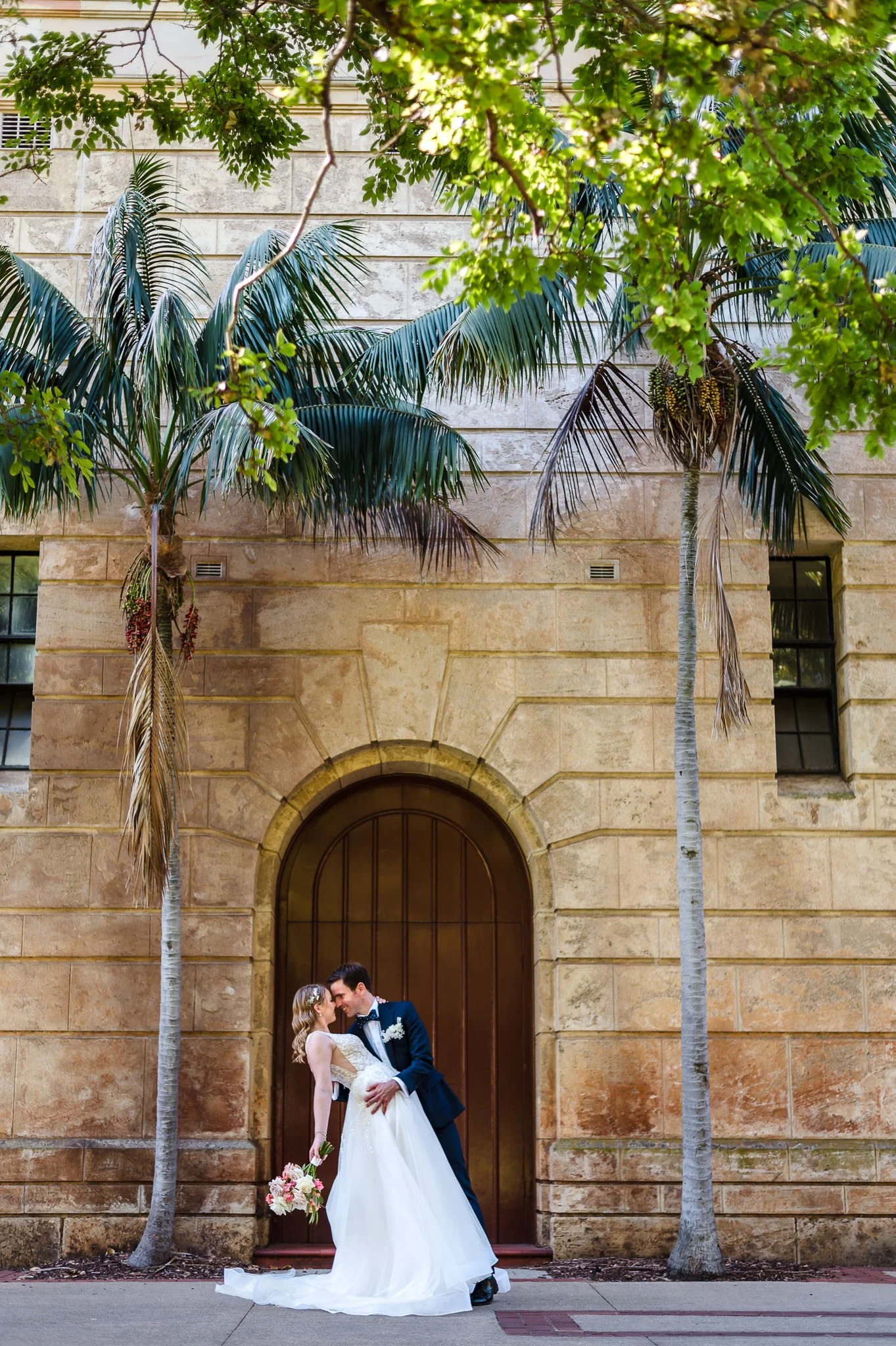 Wedding couple portrait at UWA with tropical palm trees.