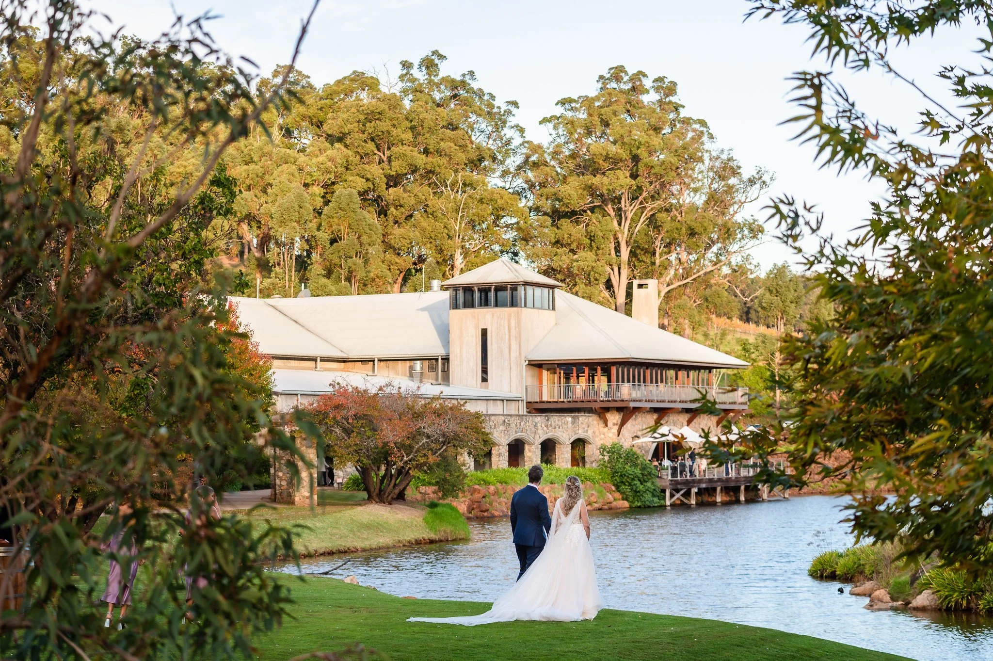 Wedding couple looking back at Millbrook Winery, their wedding venue in Jarrahdale.