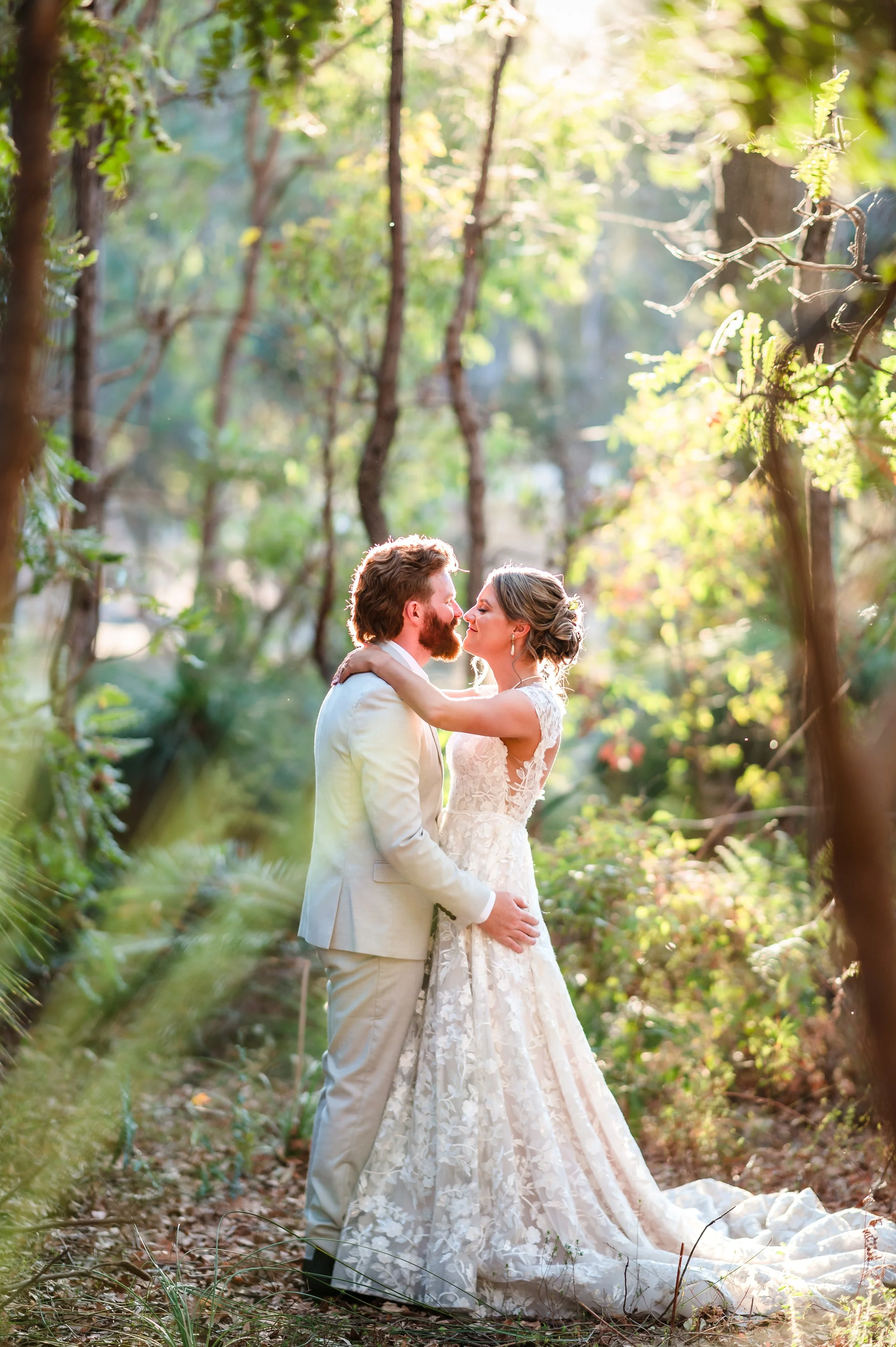 Dreamy backlit wedding portrait set in the Dwellingup Forrest at Jarrahfall Bushcamp.
