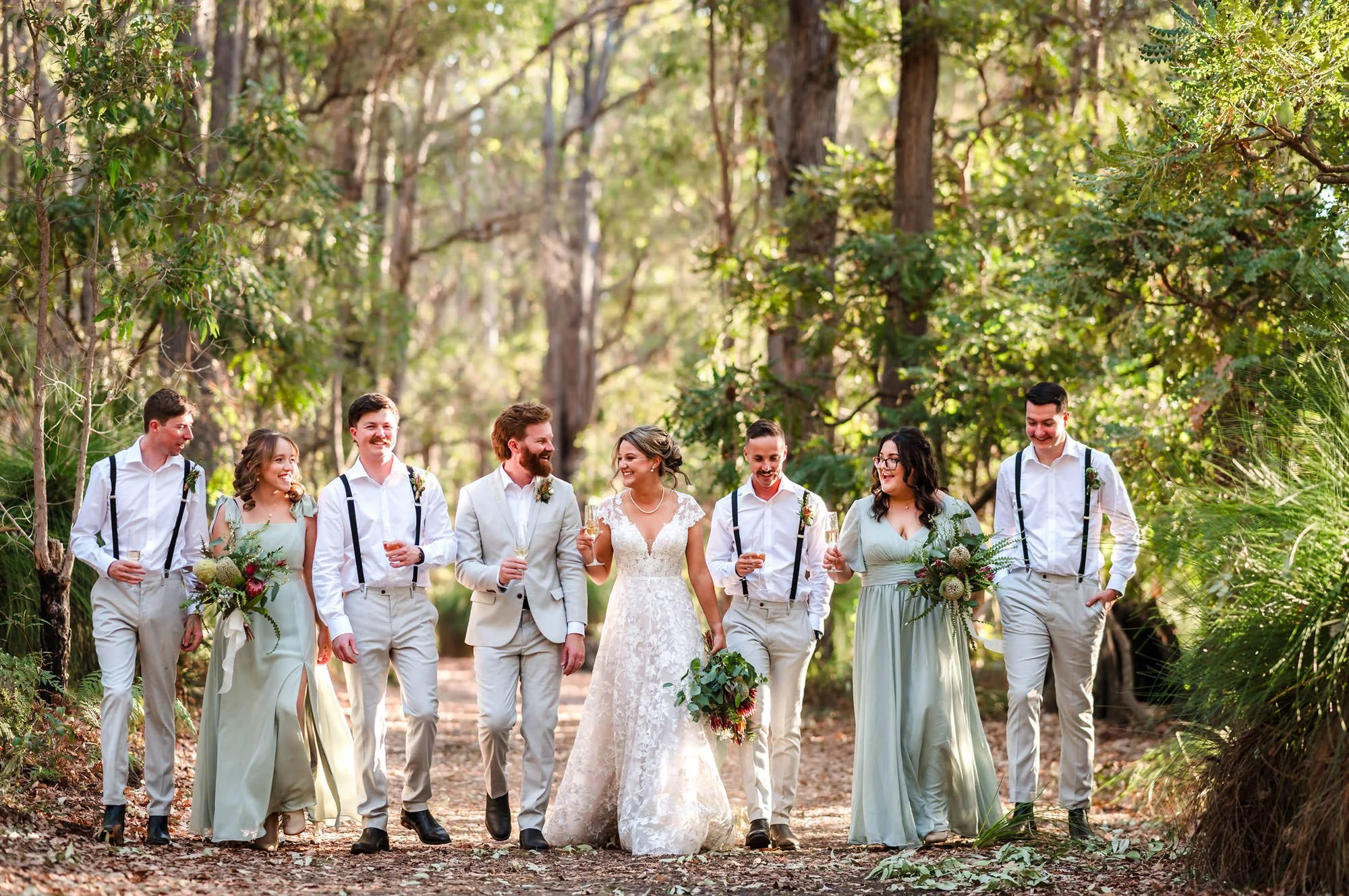 Natural bridal party photo celebrating in the Dwellingup forest at a Jarrahfall bushcamp wedding