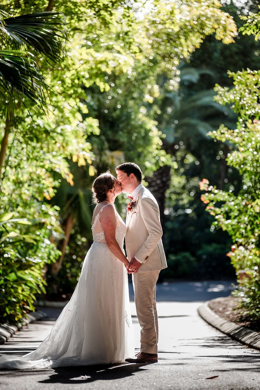 Wedding couple kissing in the laneway at the Perth Zoo
