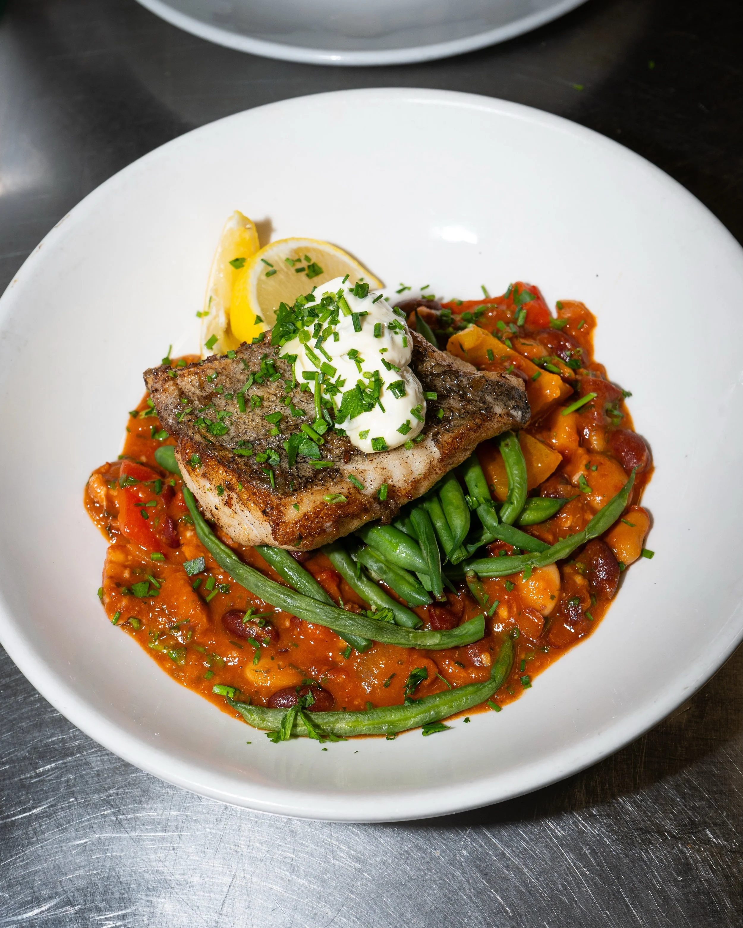 Fillet of hake on a rich tomato, bean &amp; chorizo rag&ugrave;, finished with a dollop of aioli 

A hearty, flavour-packed dish that hits the spot.

To book a table please head over to our website. 💛

#framlingham #suffolk #seafood #hake #foodie