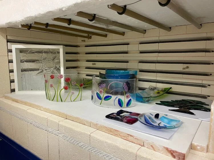 Completed glass pieces from the workshop, stored inside the kiln called The Beast.