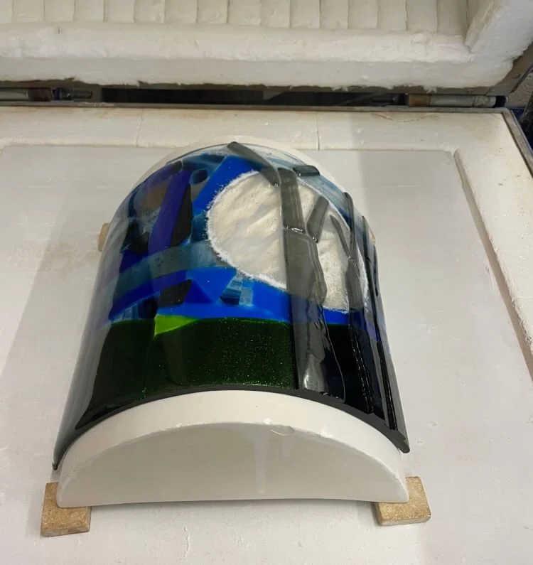 The glass winter scene has slumped around the shape of the mould.