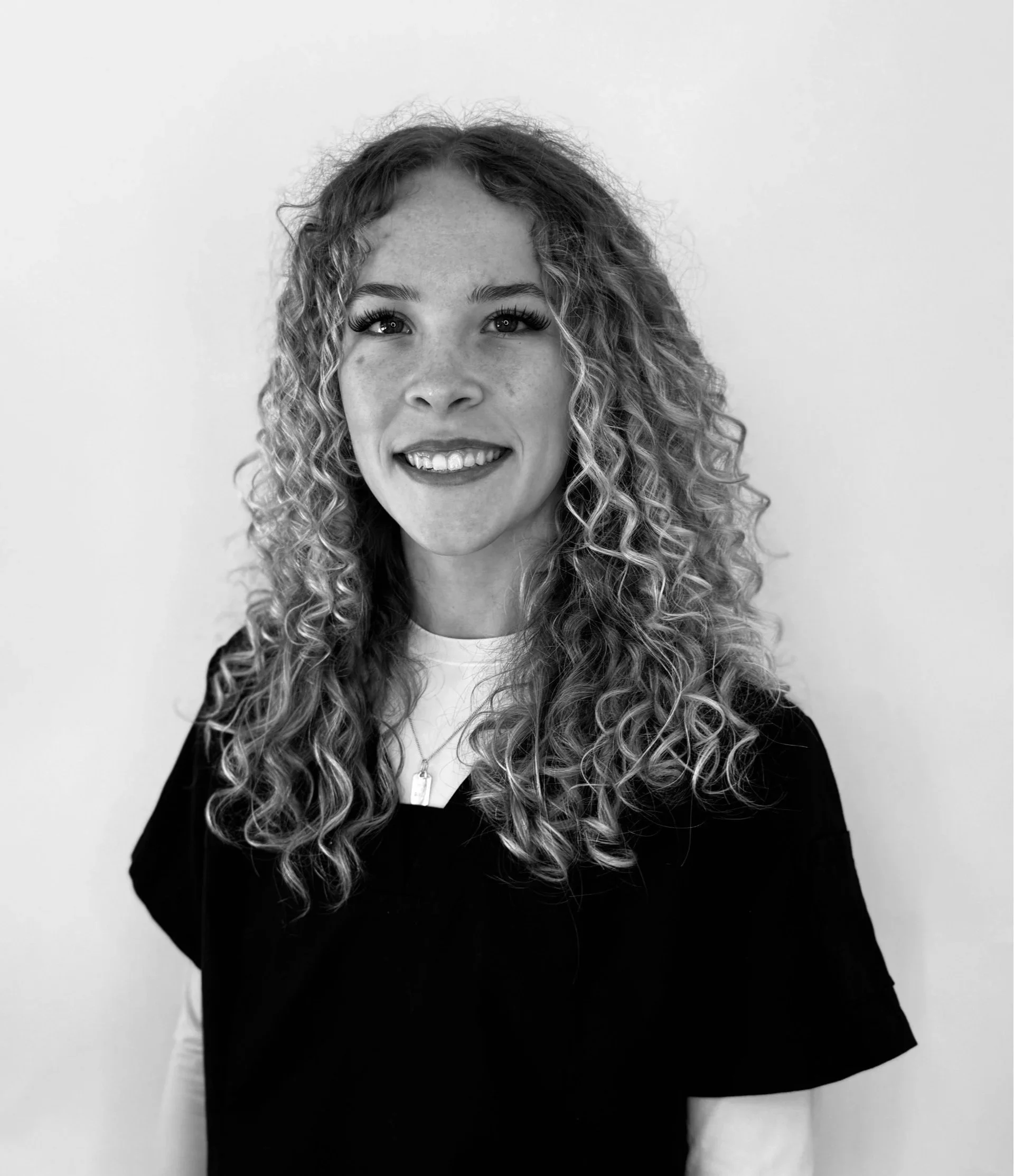 "Coming Soon" text under spotlight in dark background.