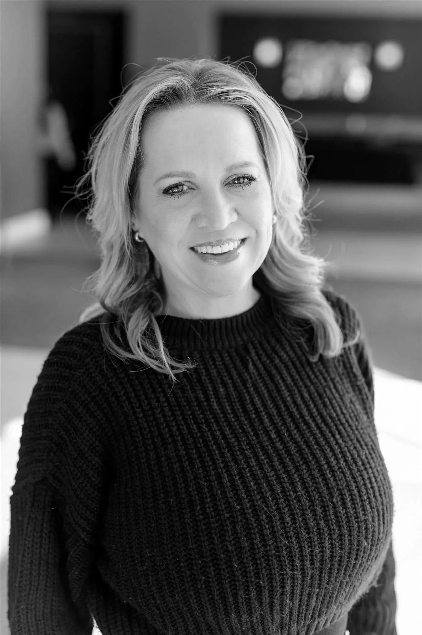 A spotlight shining down on the text 'Coming Soon' in bold letters on a dark background.