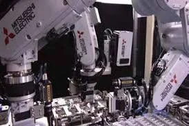 Multiple robotic arms working on electronic circuitry in a manufacturing setting.