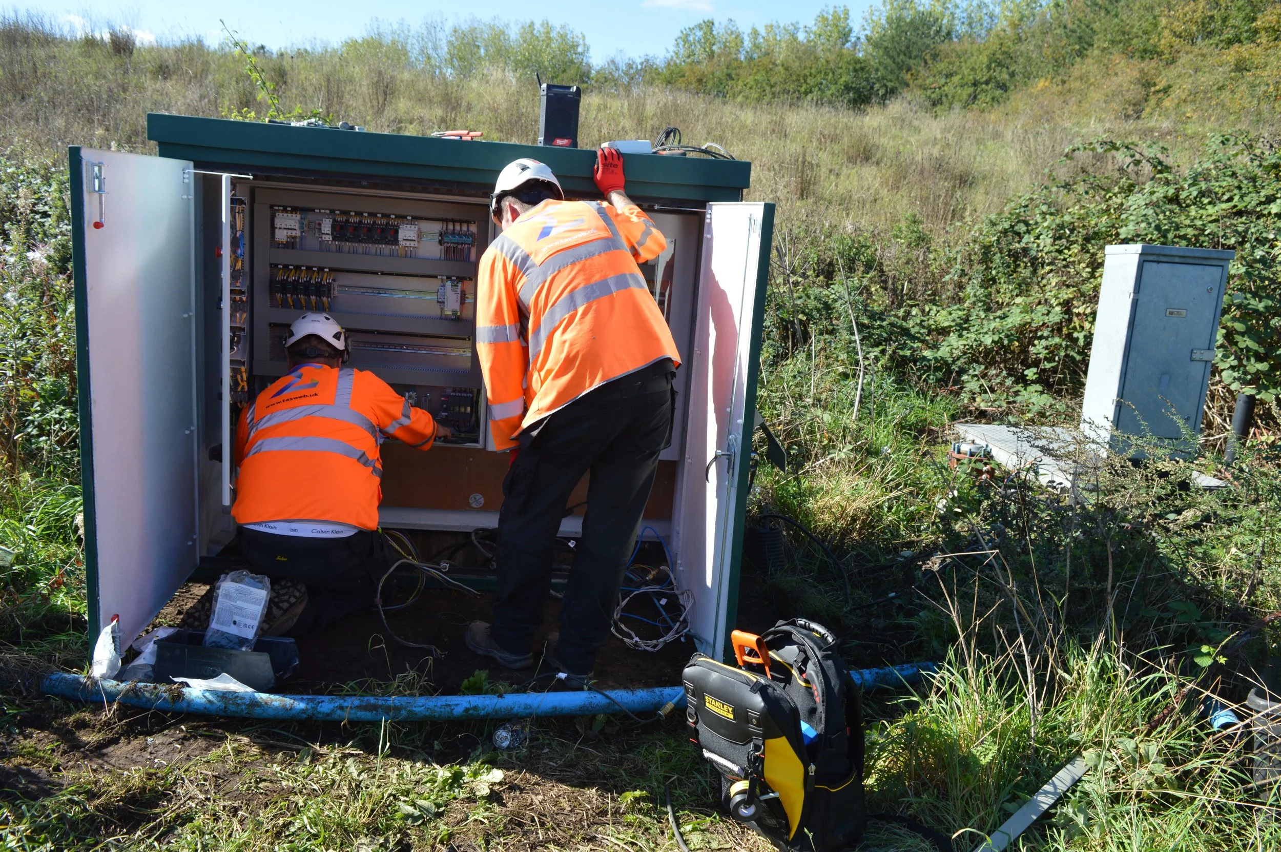 image showing lads installing the 2nd panel on site.