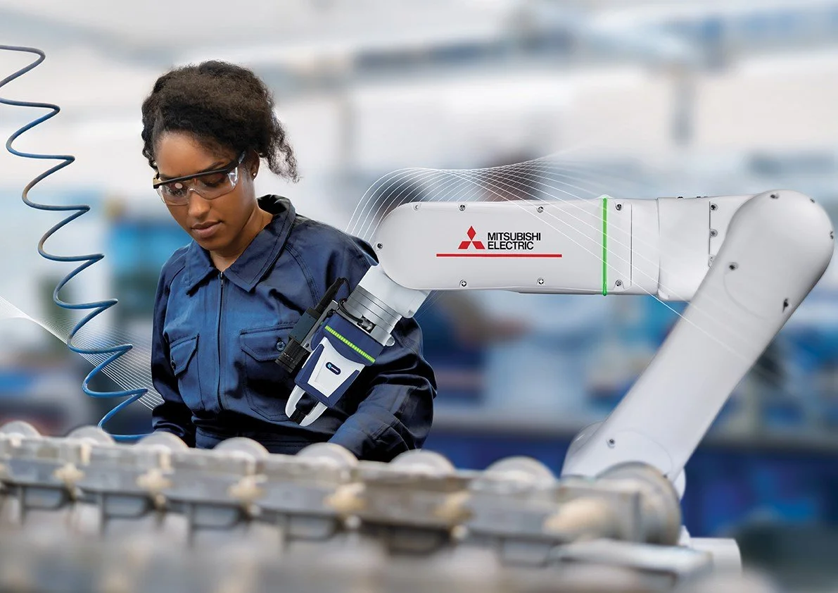 Female on producing line with Melfa Robotic Arm assisting
