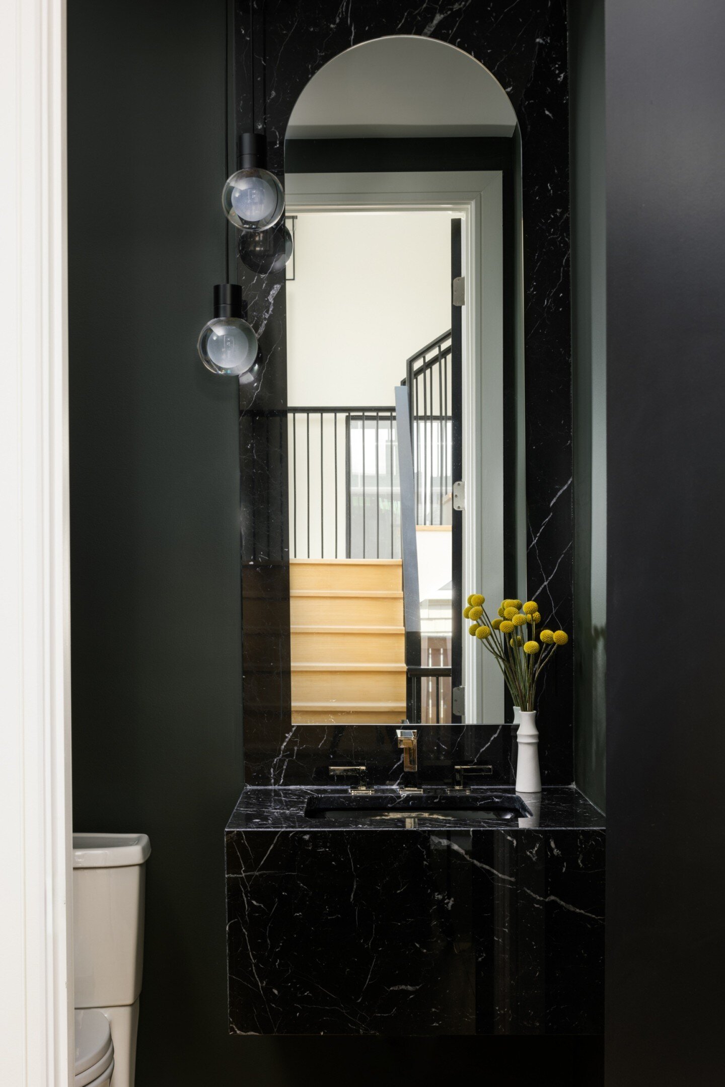 A cool, modern powder room...chic design by our designer, Sarah!  Love the arched mirror, the dark green paint, the floating black marble console and the  pendant lights👌. Well done!

Photo | @jennverrierphoto
Build | @brusharborhomes
Architect | @j